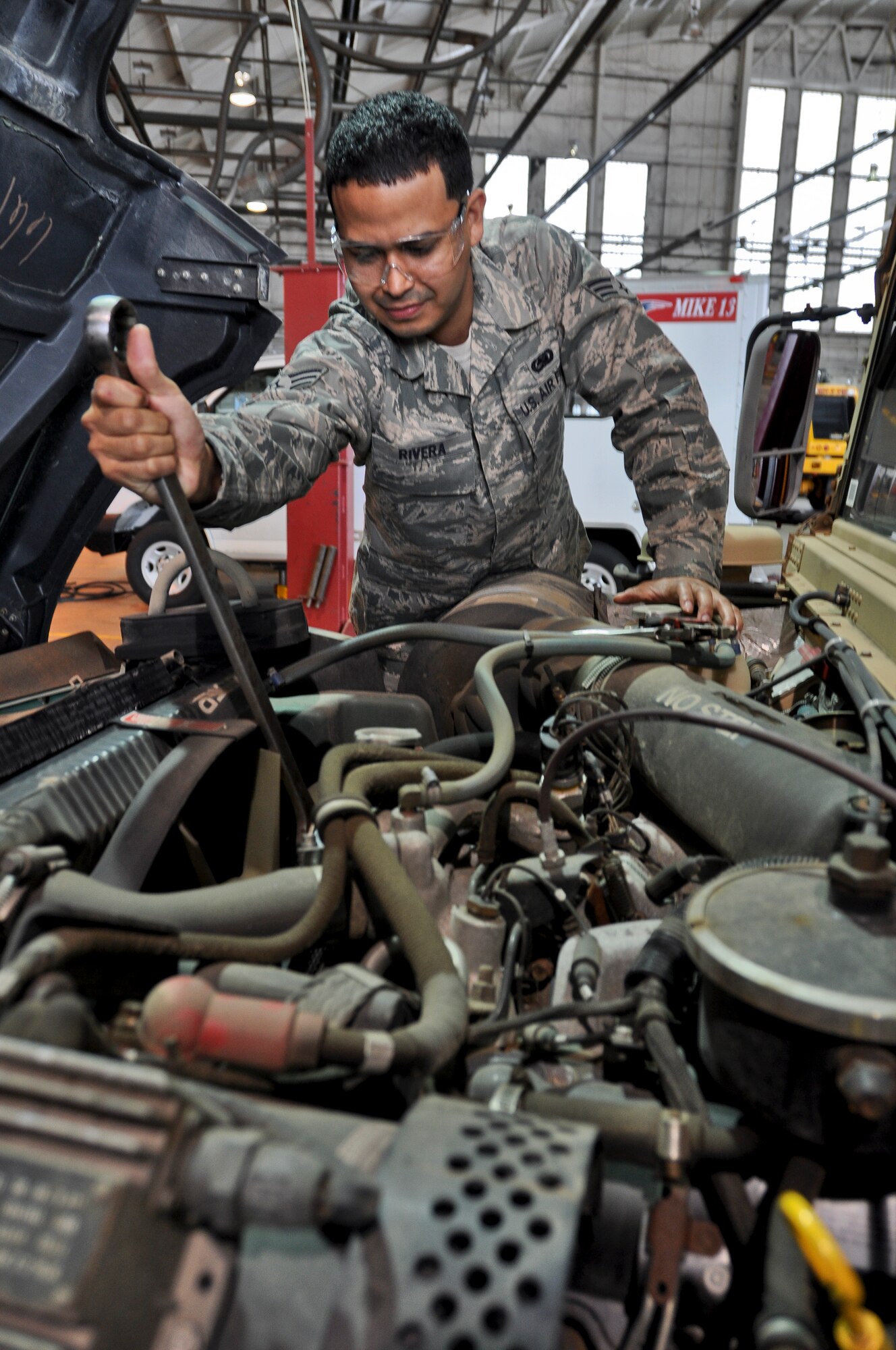SrA. Victor Rivera, 439th Logistics Readiness Squadron, performs routine vehicle maintenance inside Hangar 3 at Westover Air Reserve Base, Mass., Jan. 9, 2013. Rivera enlisted with the Air Force straight out of high school to gain structure and discipline and has since began his career as a singer-songwriter. (U.S. Air Force photo/SrA. Alexander Brown)