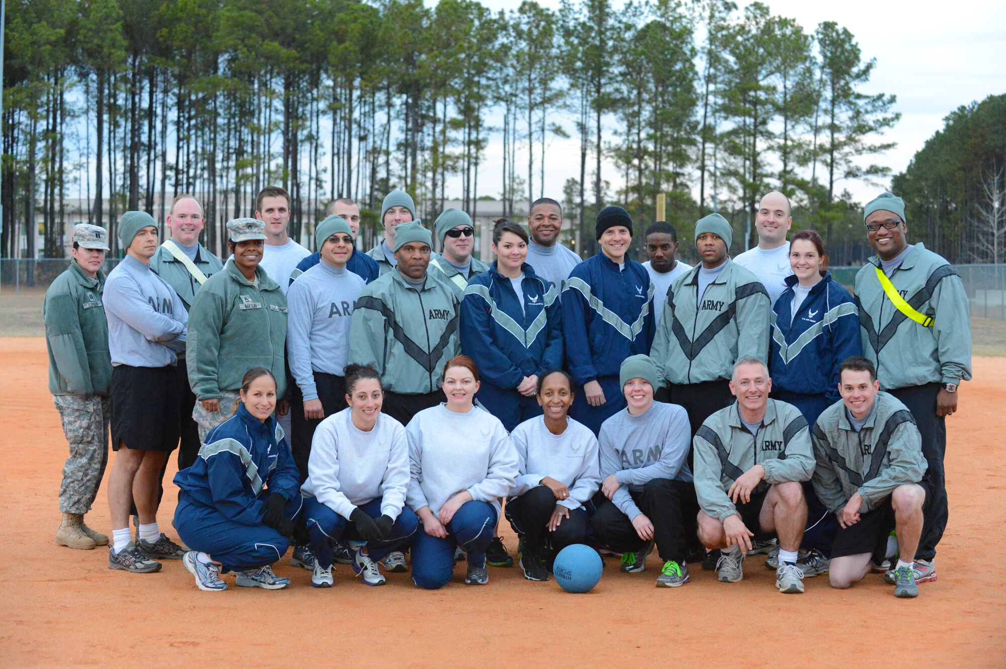 U.S. Army Central and 20th Fighter Wing legal office personnel pose for a group photo after a kickball game at Shaw Air Force Base, S.C., Nov. 25, 2013. The two offices competed in a kickball game to boost morale and strengthen relationships. (U.S. Air Force photo by Airman 1st Class Diana M. Giannetti/Released)
