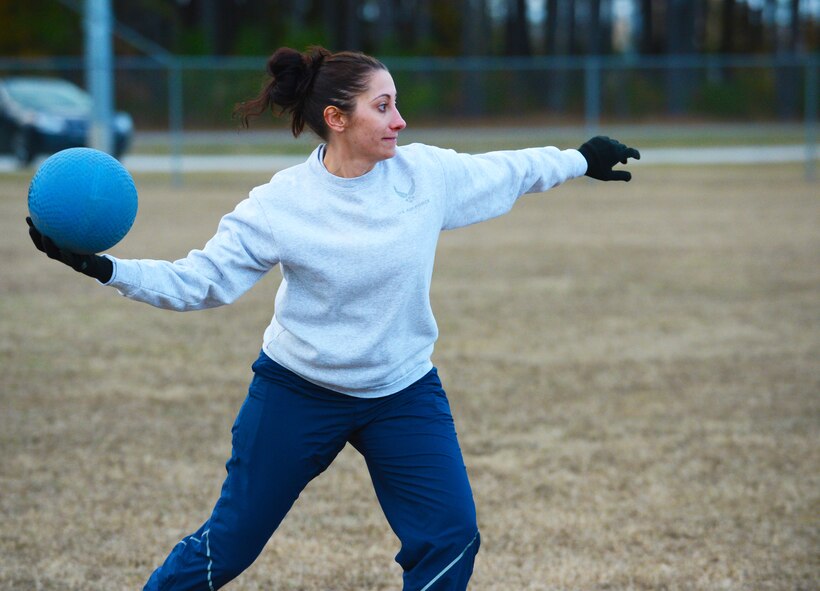 U.S. Air Force Capt. Nicole Naeser, 20th Fighter Wing legal office chief of adverse actions, passes the ball to a teammate during a kickball game at Shaw Air Force Base, S.C., Nov. 25, 2013. U.S. Army Central and 20th FW judge advocate personnel competed in a friendly game to build morale. (U.S. Air Force photo by Airman 1st Class Diana M. Giannetti/Released)