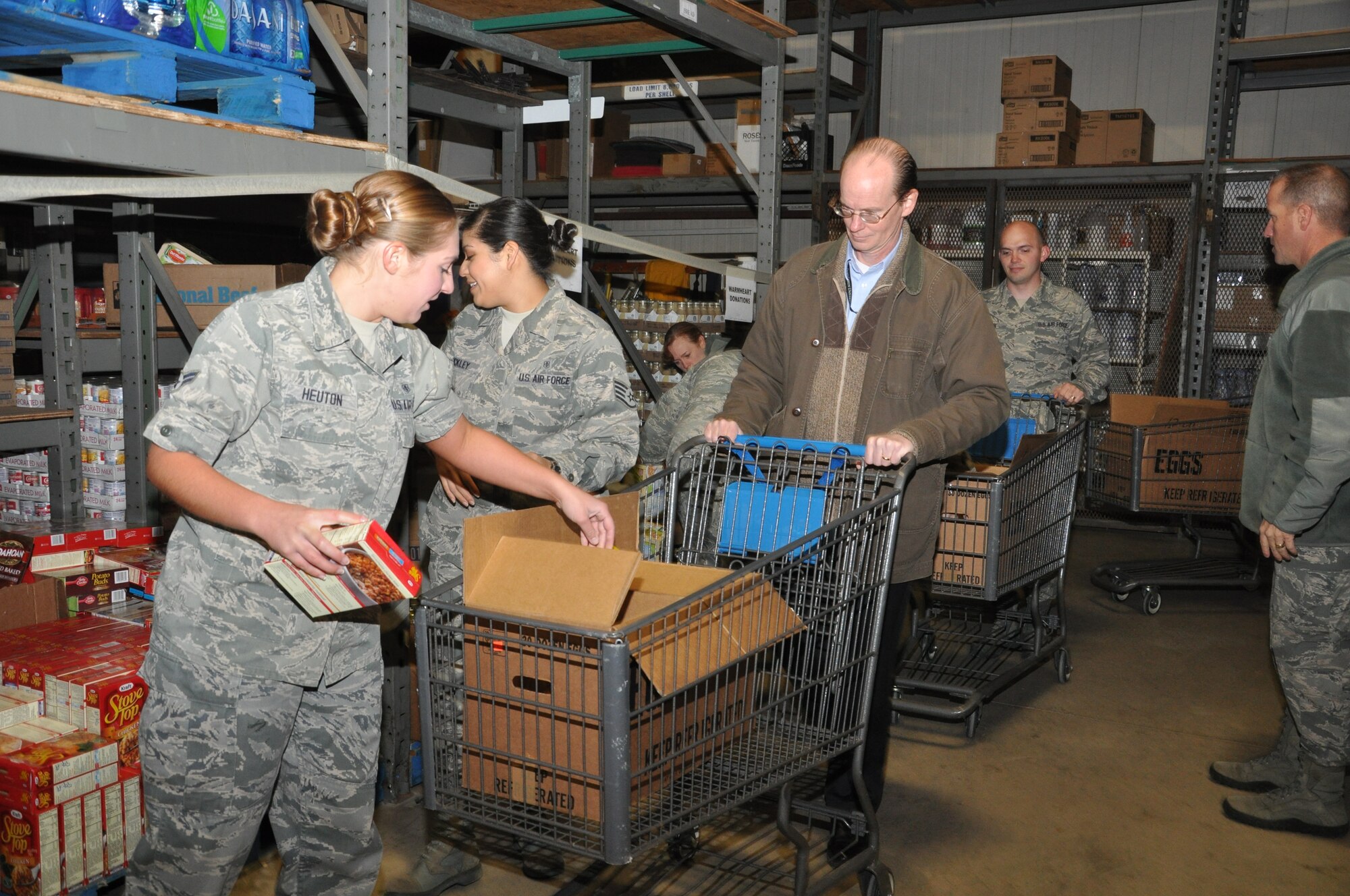 GOODFELLOW AIR FORCE BASE, Texas -- Volunteers prepare Operation Warmheart boxes at the base commissary Nov. 26. The boxes, containing a turkey and various other food items, are distributed to deserving families across the Goodfellow community for the Thanksgiving holiday. (U.S. Air Force photo/ Airman 1st Class Erica Rodriguez)