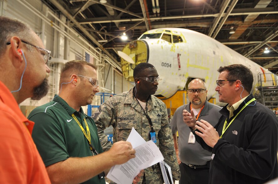 Craig Smith, right, a KC-135 unit chief with the Oklahoma City Air Logistics Complex's 564th Aircraft Maintenance Squadron, along with other members of his unit, brief Senior Master Sgt. Ricky Youngblood, a member of the Air Force Materiel Command Inspector General team. Sergeant Youngblood was conducting toolbox inspections as part of the Logistics Compliance Assessment Program. (Air Force photo by Micah Garbarino)