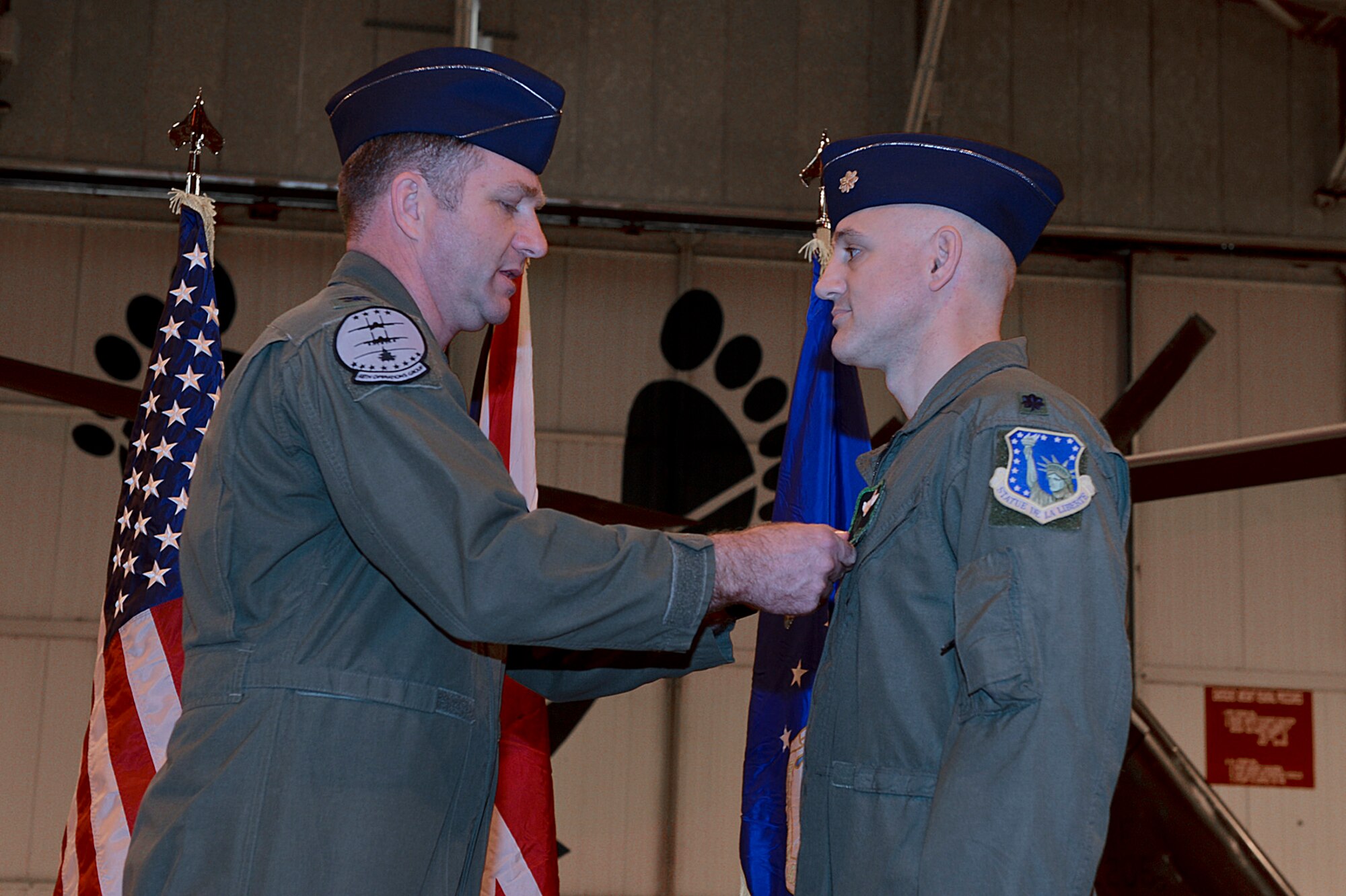 Col. Mark Slocum, 48th Operations Group commander, pins the Legion of Merit medal on Lt. Col. Bradley Dow, outgoing 56th Rescue Squadron commander, as he relinquishes command of the 56th RQS during a change of command ceremony at Royal Air Force Lakenheath, England, Nov. 26, 2013. The LOM is given to service members for exceptional meritorious conduct in the performance of outstanding services and achievements. (U.S. Air Force photo by Airman 1st Class Trevor T. McBride/Released) 