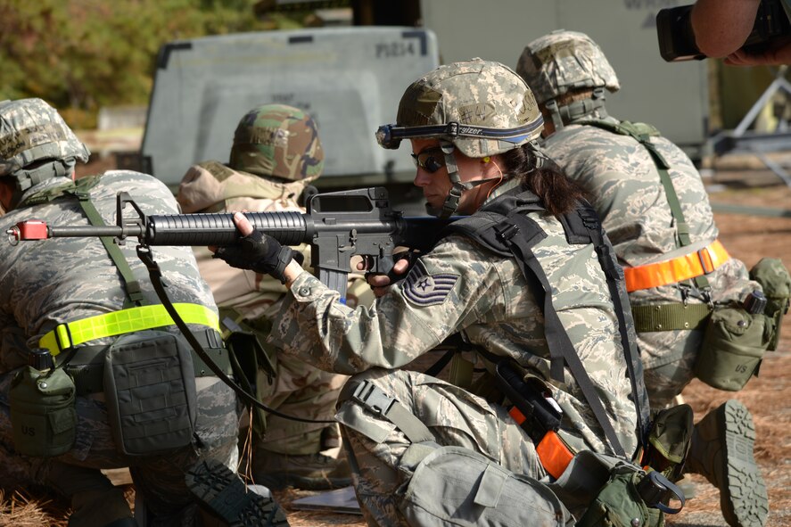 Tech. Sgt Jessica Forham, 402nd Expeditionary Depot Maintenance Flight sheet metal technician, defends her comrade's back from attack during the recent EDMX operational readiness exercise at Warrior Air Base. (U.S. Air Force photo/Ray Crayton)