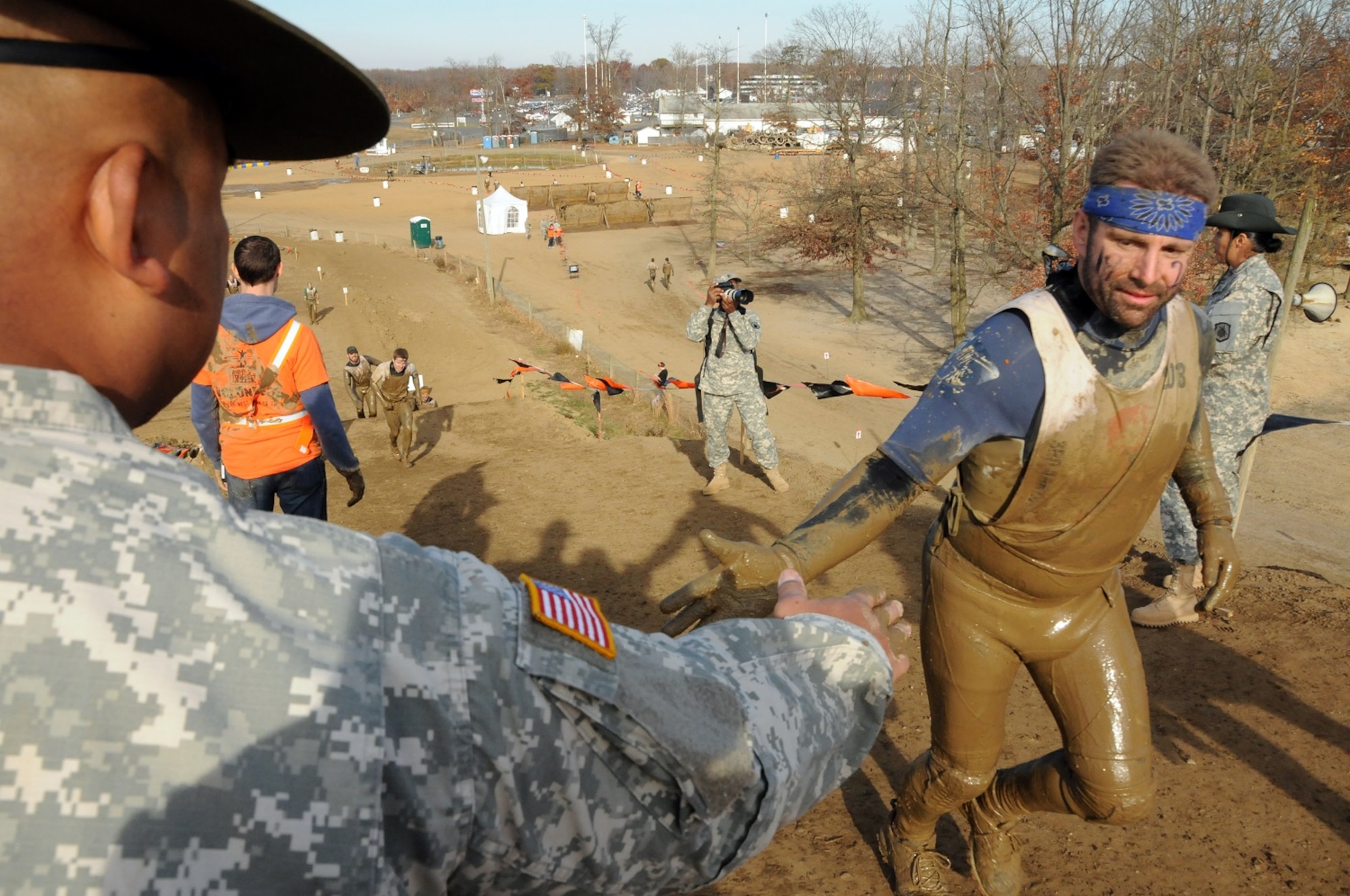 Drill sergeants with the Army Reserve’s 3rd Battalion, 385th Regiment, motivate competitors during the World’s Toughest Mudder event Nov. 15-17, 2013, at Raceway Park in Englishtown, N.J. The drill sergeants joined nearly six-dozen of their fellow Citizen-Soldiers to support the World’s Toughest Mudder competitors as they attempted to complete the grueling five-mile obstacle course as many times as possible within a 24-hour period. (U.S. Army photo by Sgt. Salvatore Ottaviano/Released)