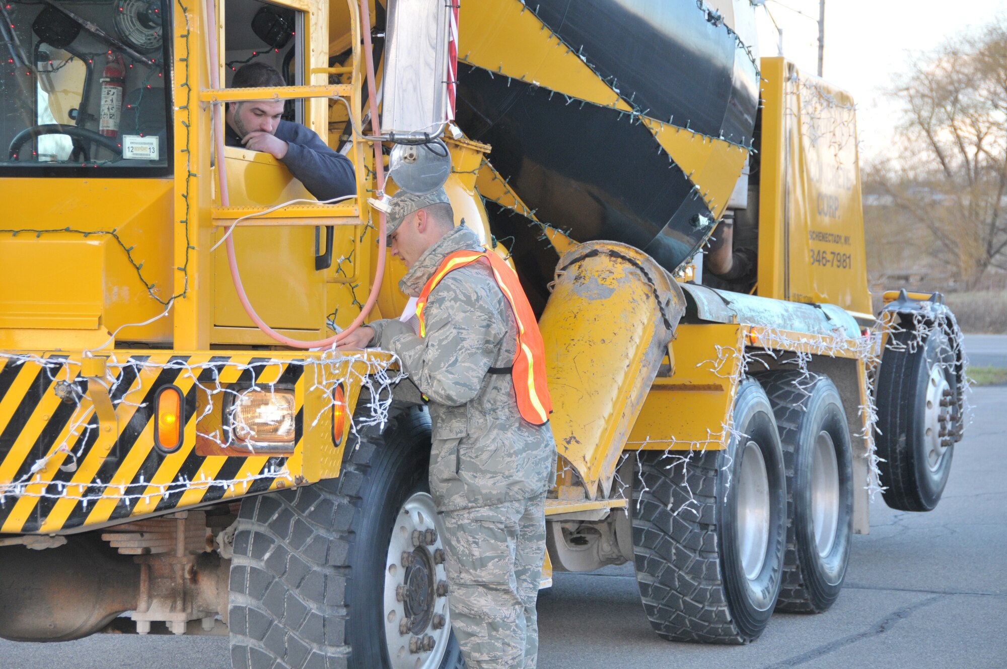SCHENECTADY, N.Y. -- 2nd Lt. Jared Semerad, 109th Logistics Readiness Squadron, directs a parade participant where to park in preparation for the 46th annual Gazette Holiday Parade on Nov. 23, 2013. About 20 volunteers with the 109th Airlift Wing, including some family members, volunteered to help usher the floats in for the parade. (Air National Guard photo by Tech. Sgt. Catharine Schmidt/Released)