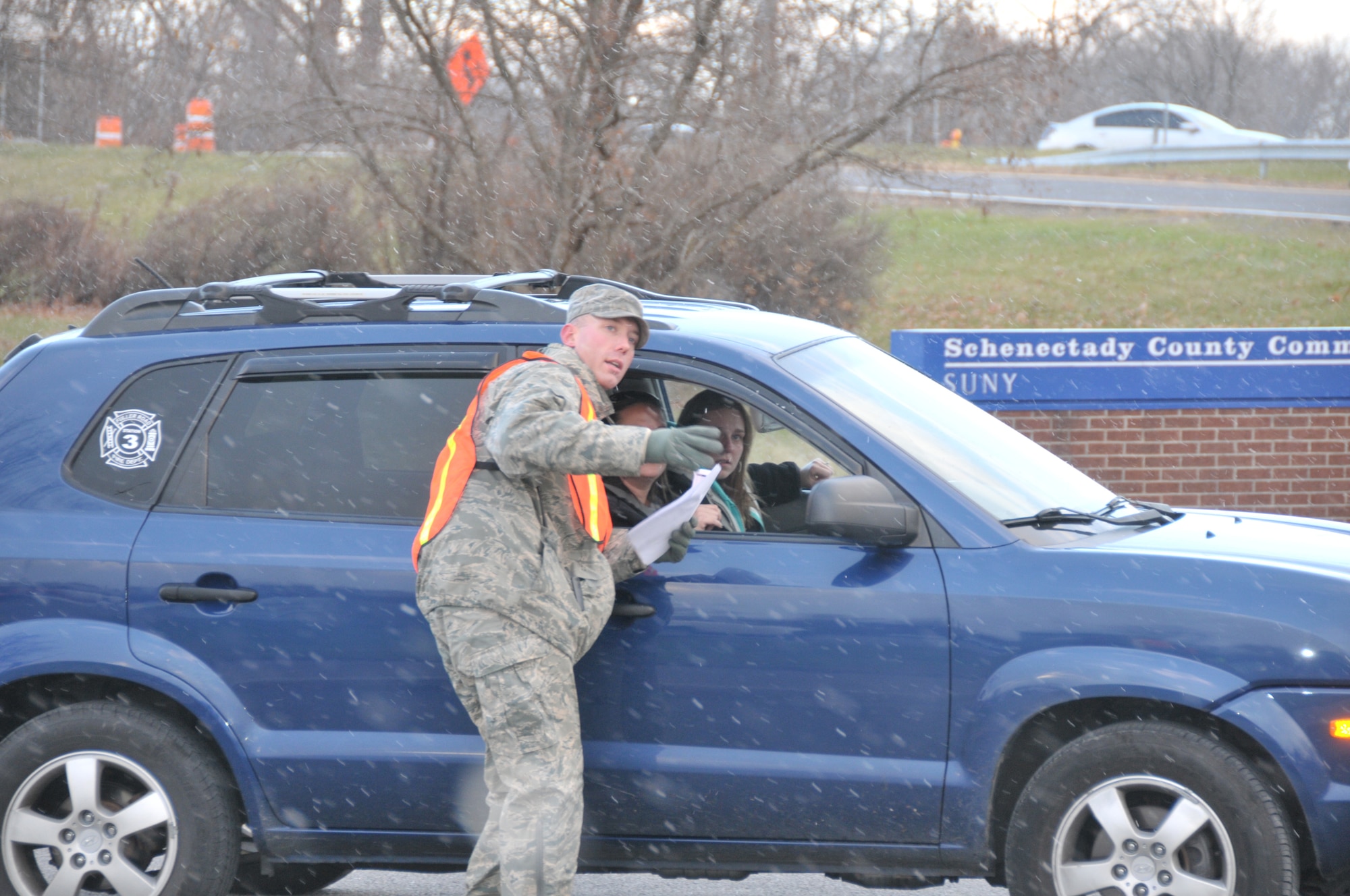 SCHENECTADY, N.Y. -- Tech. Sgt. Matthew Begin, 109th Maintenance Group, directs a parade participant where to park in preparation for the 46th annual Gazette Holiday Parade on Nov. 23, 2013. About 20 volunteers with the 109th Airlift Wing, including some family members, volunteered to help usher the floats in for the parade. (Air National Guard photo by Tech. Sgt. Catharine Schmidt/Released)