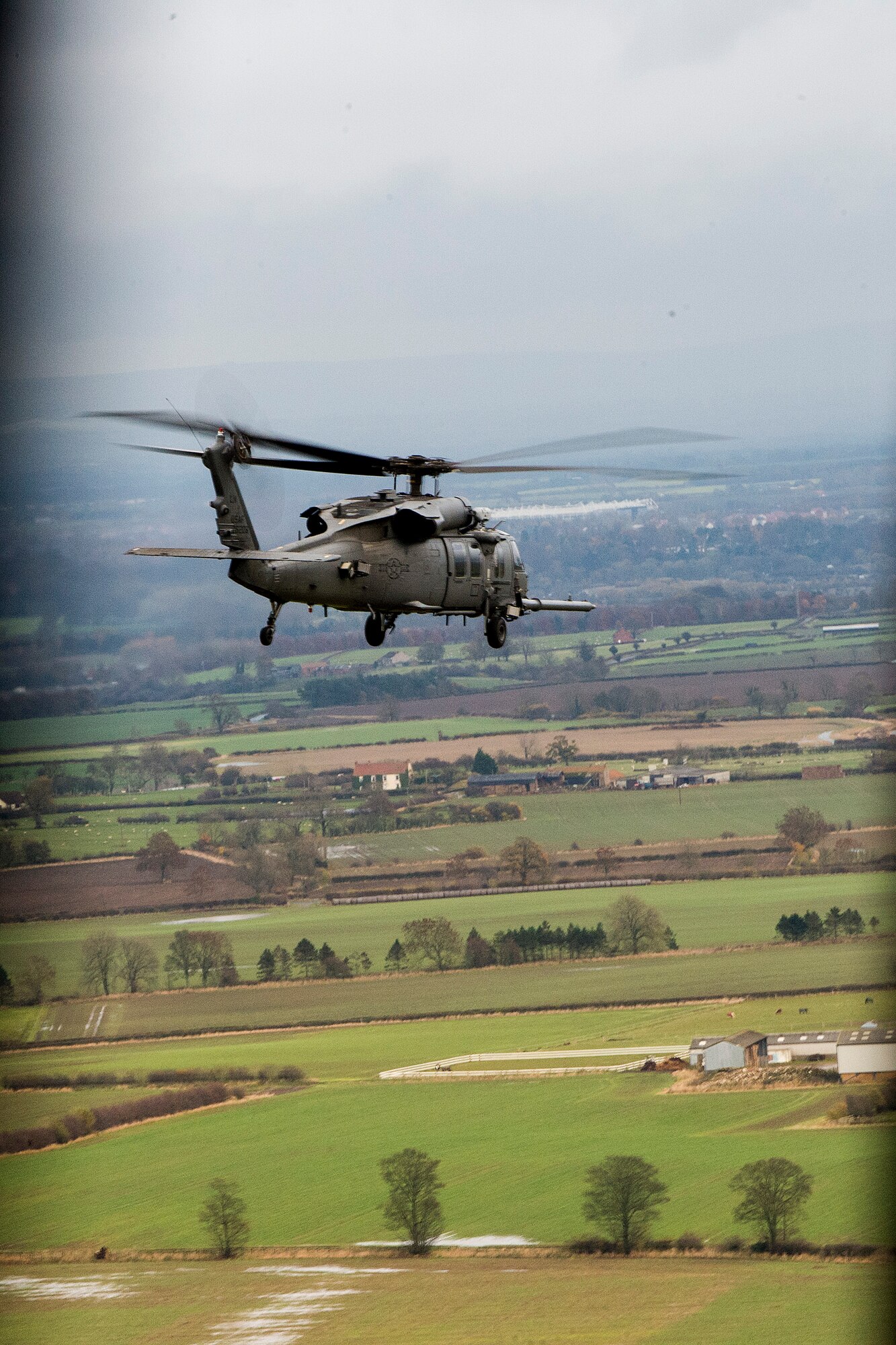 An HH-60G Pave Hawk assigned to the 56th Rescue Squadron travels to the Royal Air Force Spadeadam Electronic Warfare Test Range Nov. 21, 2013. The 56th RQS rehearsed engagement of air defenses and ground threats as part of an exercise Nov. 18-22. (U.S. Air Force photo by Airman 1st Class Trevor T. McBride/Released)