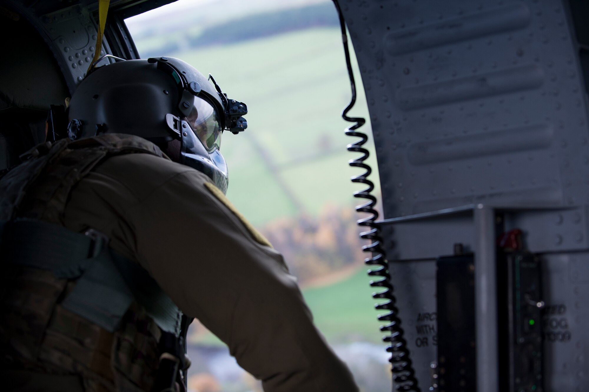 Master Sgt. Randy Van Horn, 48th Operations Group special missions aviator evaluator, communicates observations to the other aircrew in an HH-60G Pave Hawk Nov. 21, 2013, while en route to the Royal Air Force Spadeadam Electronic Warfare Test Range. The 56th RQS rehearsed engagement of air defenses and ground threats as part of an exercise Nov. 18-22. (U.S. Air Force photo by Airman 1st Class Trevor T. McBride/Released)