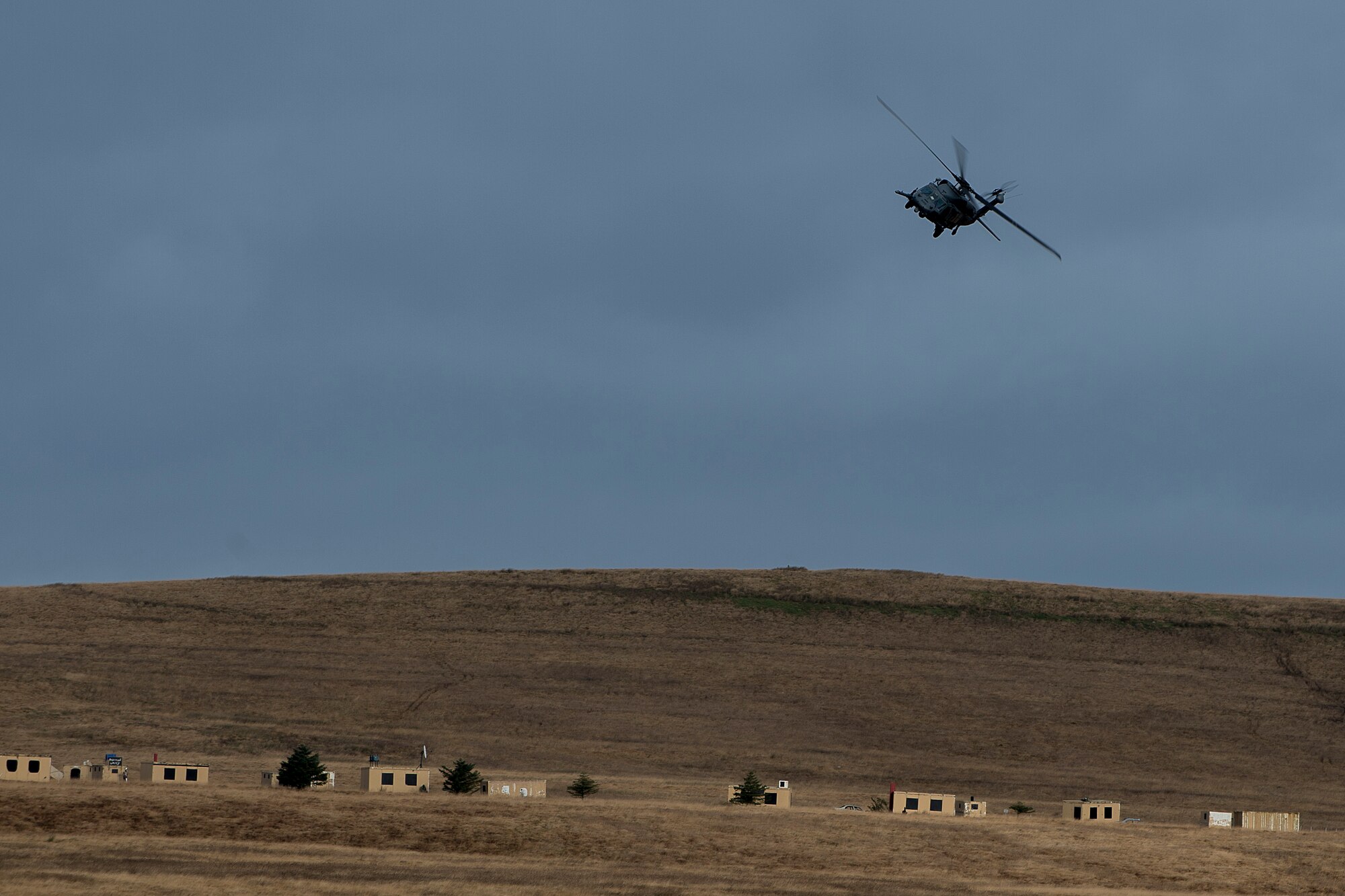 An HH-60G Pave Hawk assigned to the 56th Rescue Squadron swoops from the sky during electronic warfare training over the Royal Air Force Spadeadam Electronic Warfare Test Range Nov. 20, 2013. The 56th RQS rehearsed engagement of air defenses and ground threats as part of an exercise Nov. 18-22. (U.S. Air Force photo by Airman 1st Class Trevor T. McBride/Released