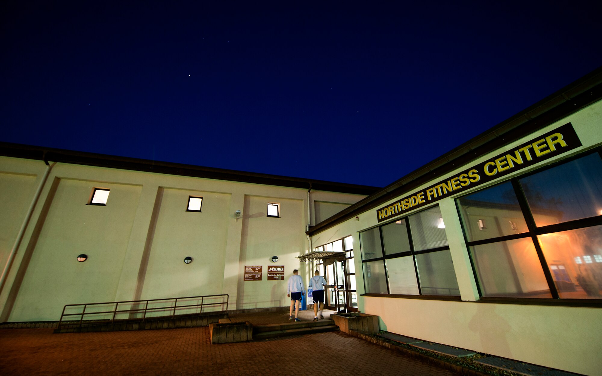 Airmen enter the Ramstein Northside Fitness Center, Nov. 26, 2013, Ramstein Air Base, Germany. Starting Jan. 1, the Northside Fitness Center will available to service members and other identification card holders, 4 a.m. Monday through 12 a.m. Friday. (U.S. Air Force photo/Senior Airman Damon Kasberg)