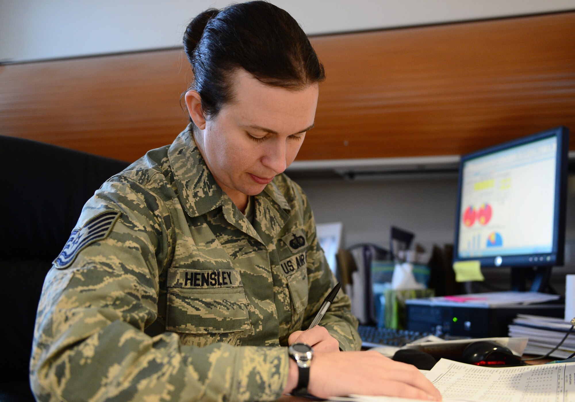 Tech. Sgt. Jessica M. Hensley, 48th Force Support Squadron food service accountant, reviews budget paperwork at Royal Air Force Lakenheath, England, Nov. 27, 2013. Hensley was nominated for a Liberty Spotlight because she displays the core value of Excellence in All We Do. (U.S. Air Force photo by Airman 1st Class Dawn M. Weber/Released)  