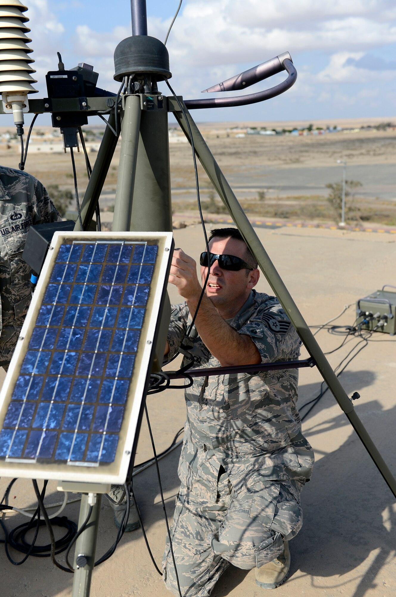 Staff Sgt. David Glowacki, 386th Expeditionary Operations Support Squadron, weather technician, replaces the canister over the logger and pressure sensor on the Tactical Meteorological Observing System, TMQ-53 during the quarterly preventative maintenance inspection here, Nov. 21, 2013. Glowacki is deployed out of the 437th Operations Support Squadron, Joint Base Charleston, Charleston, S.C., and is a native of Buffalo, N. Y.  (U.S. Air Force photo by Master Sgt. Christopher A. Campbell)
