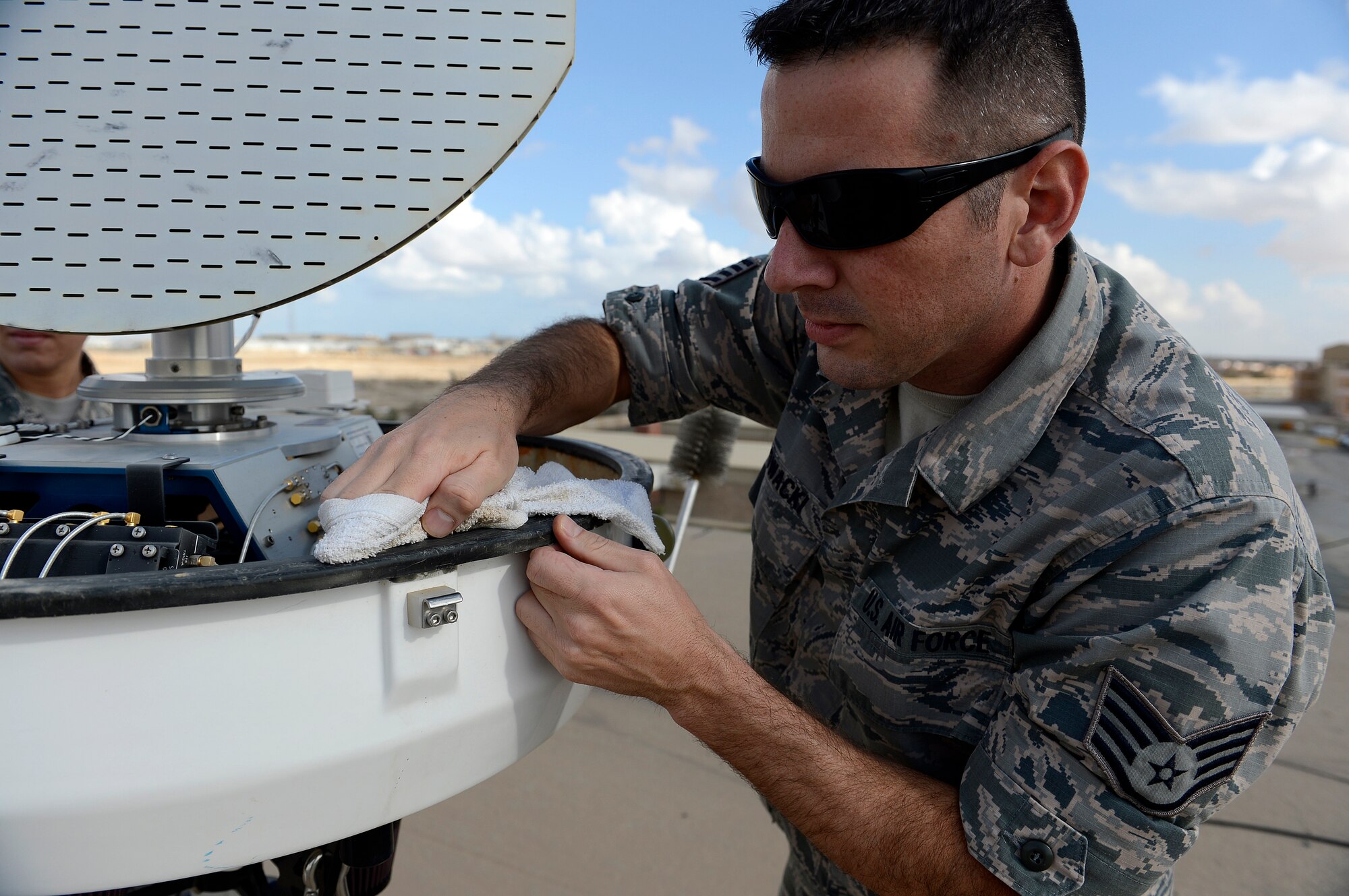 Staff Sgt. David Glowacki, 386th Expeditionary Operations Support Squadron, weather technician, wipes down the E700XD Portable Doppler Radar during monthly preventative maintenance here, Nov. 21, 2013. Glowacki is deployed out of the 437th Operations Support Squadron, Joint Base Charleston, Charleston, S.C., and is a native of Buffalo, N. Y. (U.S. Air Force photo by Master Sgt. Christopher A. Campbell)