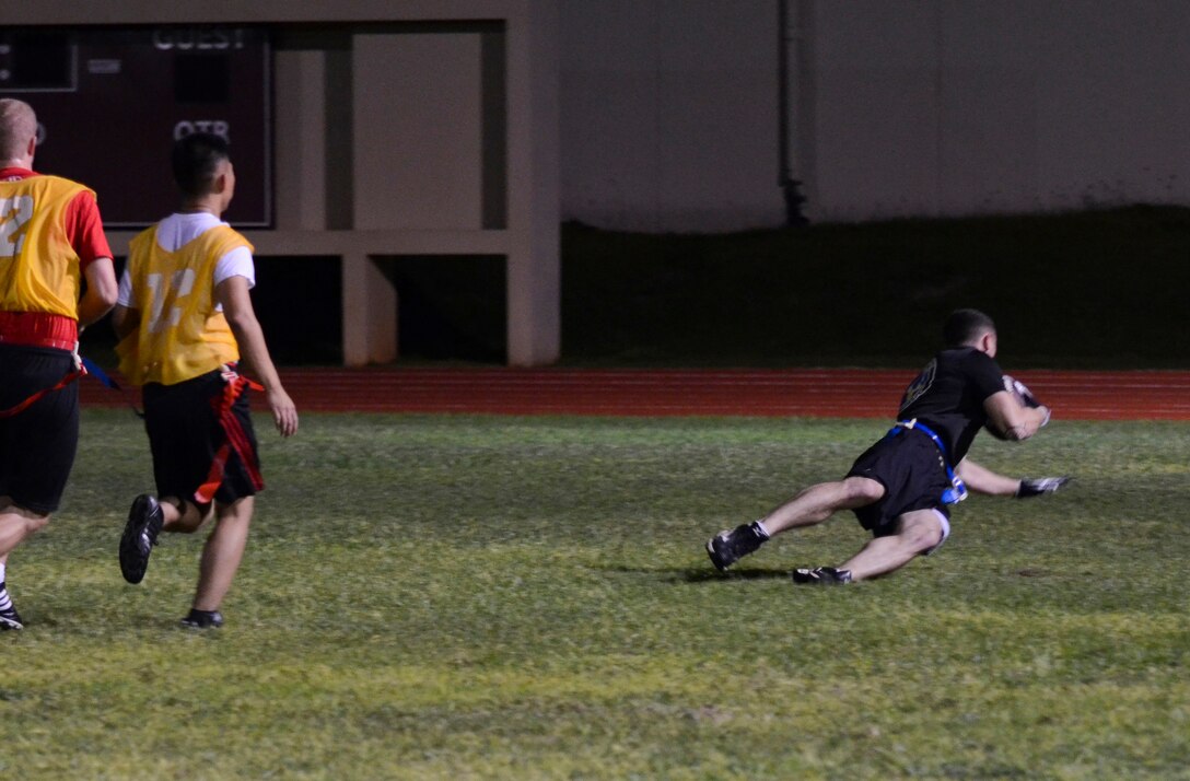 Christopher Durham, 94th Army Air and Missile Defense Command, catches the ball in the end zone during an intramural flag football game Nov. 25, 2013, on Andersen Air Force Base, Guam. The 94th AAMDC defeated 22nd Space Operations Squadron Detachment 5, 40-0. (U.S. Air Force photo by Senior Airman Marianique Santos/Released)
