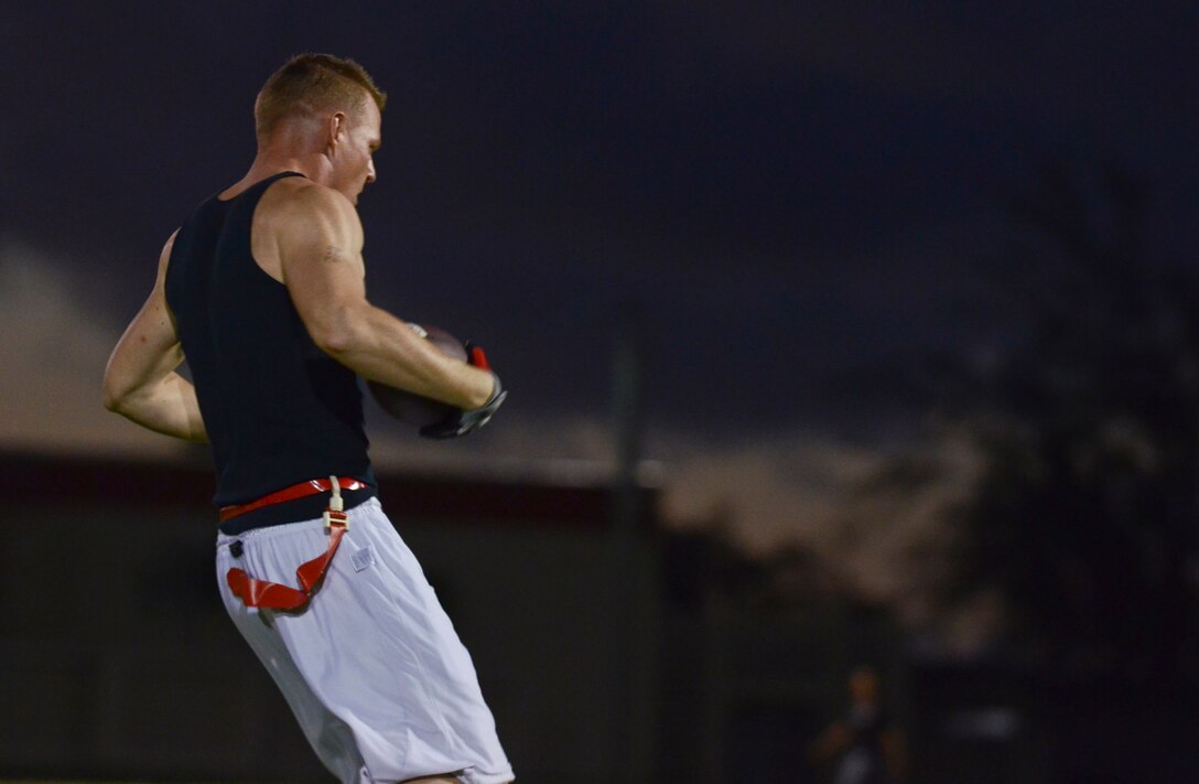 Robert Pepperling, 94th Army Air and Missile Defense Command, halts after one of his flags is pulled during an intramural flag football game Nov. 25, 2013, on Andersen Air Force Base, Guam. The 94th AAMDC defeated 22nd Space Operations Squadron Detachment 5, 40-0. (U.S. Air Force photo by Senior Airman Marianique Santos/Released)