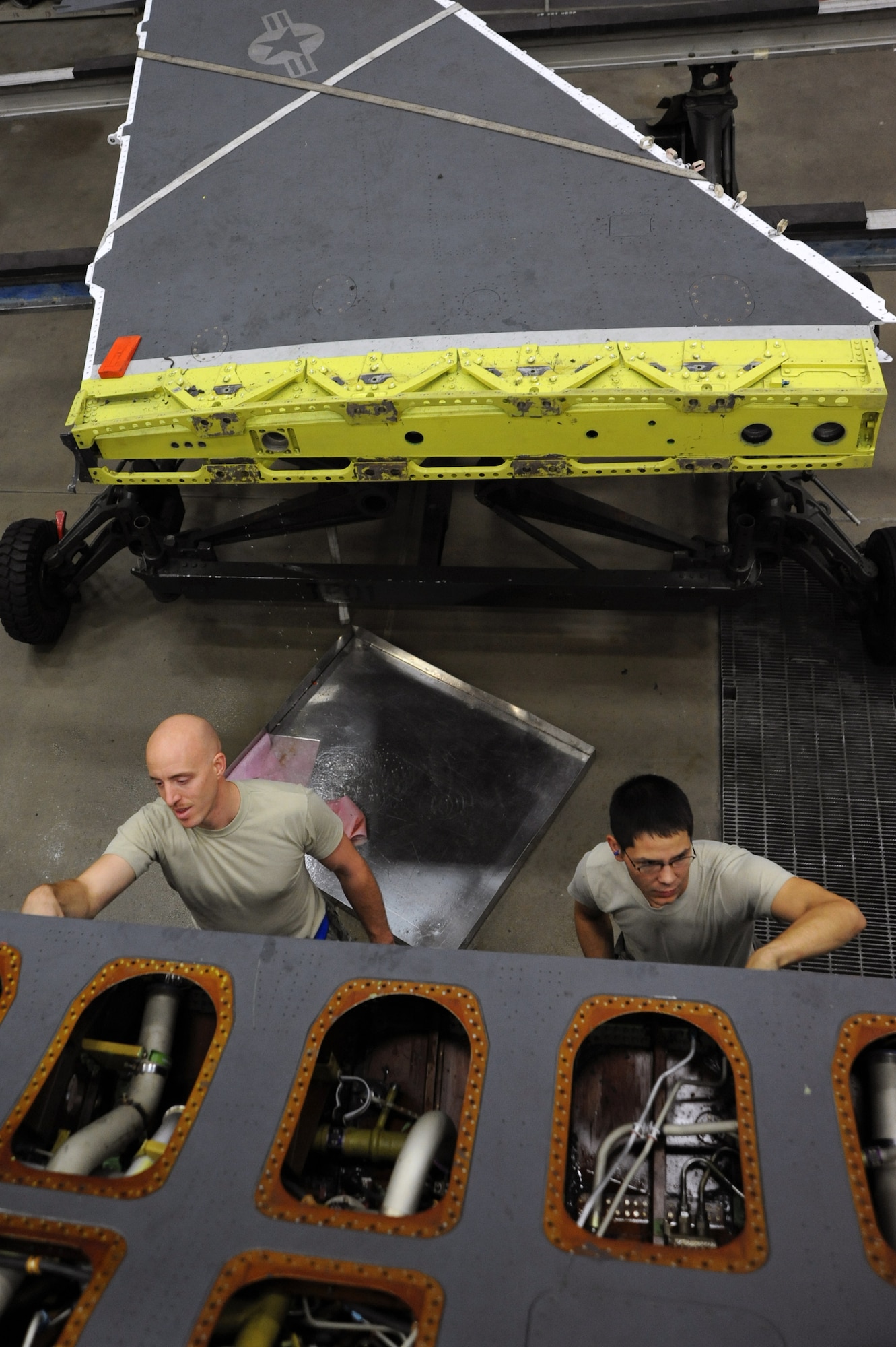 Tech. Sgt. Jeffrey Cornell, left, 35th Maintenance Squadron, and Staff Sgt. Brent Cratty, 35 MXS, inspect a U.S. Air Force F-16 Fighting Falcon after removing its wing Nov. 18, 2013, at Misawa Air Base, Japan. Maintainers from the 35 MXS have streamlined the wing change process at Misawa following an Air Force-wide inspection that prompted several wing changes. (U.S. Air Force photo by Senior Airman Derek VanHorn)