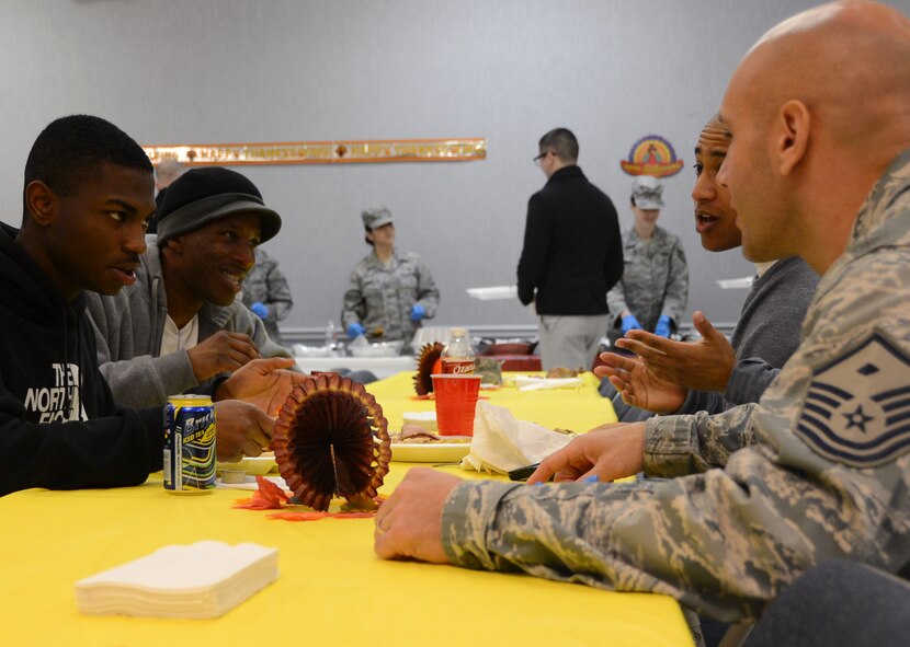 A first sergeant speaks with Airmen during a Thanksgiving luncheon for dorm Airmen on Barksdale Air Force Base, La., Nov. 28, 2013. Commanders, chiefs and first sergeants as well as volunteers from several base organizations took time away from their families to prepare and serve a Thanksgiving meal to dorm Airmen who were unable to go home for the holiday. (U.S. Air Force photo/Staff Sgt. Amber Corcoran)
