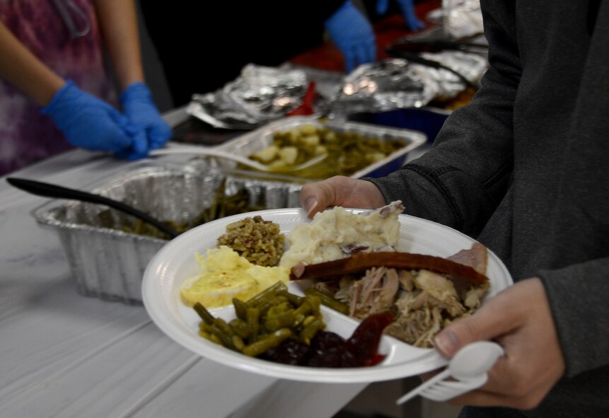 An Airman chooses sides to accompany his turkey and ham during a Thanksgiving luncheon for dorm Airmen on Barksdale Air Force Base, La., Nov. 28, 2013. Several base private organizations were responsible for bringing desserts, side dishes and utensils and base commanders and chiefs were responsible for the turkeys and hams. (U.S. Air Force photo/Staff Sgt. Amber Corcoran)
