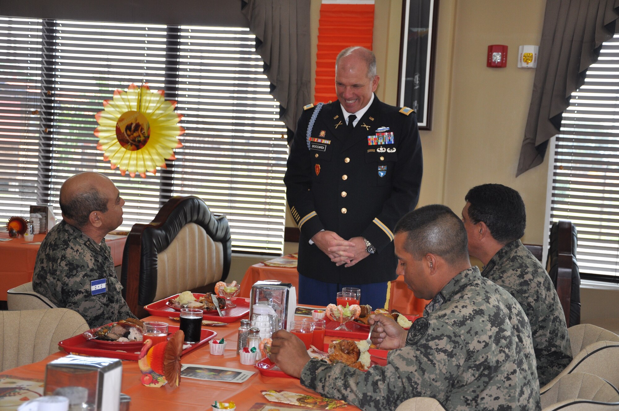 U.S. Army Col. Thomas Boccardi, Joint Task Force-Bravo Commander. visits with leaders from the Honduran Air Force during a Thanksgiving Day meal served at the dining facility at Soto Cano Air Base, Honduras, Nov. 28, 2013. Joint Task Force-Bravo members were treated to a Thanksgiving Day meal with all the trimmings in celebration of the holiday.  Joint Task Force-Bravo leadership, as well as leaders from the Army Support Activity, Army Forces Battalion, Joint Security Forces, 612th Air Base Squadron, 1-228th Aviation Regiment, and Medical Element wore their dress uniforms and served the members of the Task Force. (U.S. Air Force photo by Capt. Zach Anderson)
 