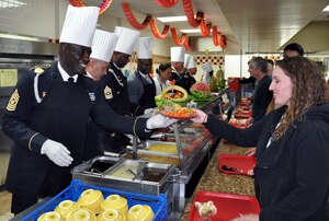 U.S. Army Command Sgt. Maj. Norriel Fahie, Army Support Activity, serves a plate of Thanksgiving dinner to a member of Joint Task Force-Bravo at the Soto Cano Air Base dining facility, Nov. 26, 2013.  Members of Joint Task Force-Bravo were treated to a Thanksgiving Day meal with all the trimmings in celebration of the holiday.  Joint Task Force-Bravo leadership, as well as leaders from the Army Support Activity, Army Forces Battalion, Joint Security Forces, 612th Air Base Squadron, 1-228th Aviation Regiment, and Medical Element wore their dress uniforms and served the members of the Task Force. (U.S. Air Force photo by Capt. Zach Anderson)
