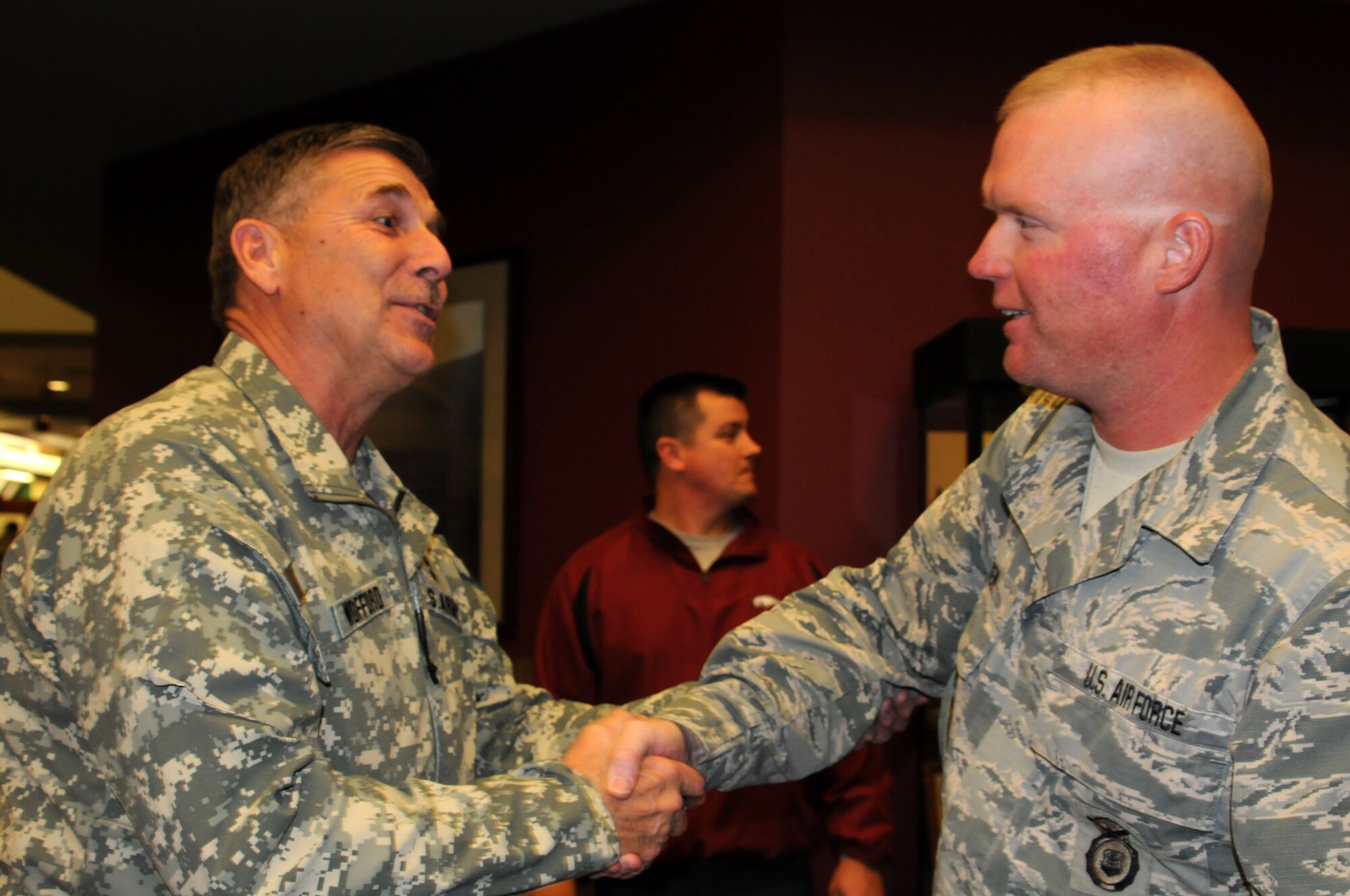 Maj. Gen. William Wofford, Arkansas National Guard adjutant general, left, shakes the hand of Master Sgt. David Passen at the Fort Smith (Ark.) Regional Airport Nov. 27, 2013. Passen was one of 13 Airmen with the 188th Security Forces Squadron who returned just in time to spend the Thanksgiving holiday with his family. (U.S. Air National Guard photo by Maj. Heath Allen/188th Fighter Wing)
