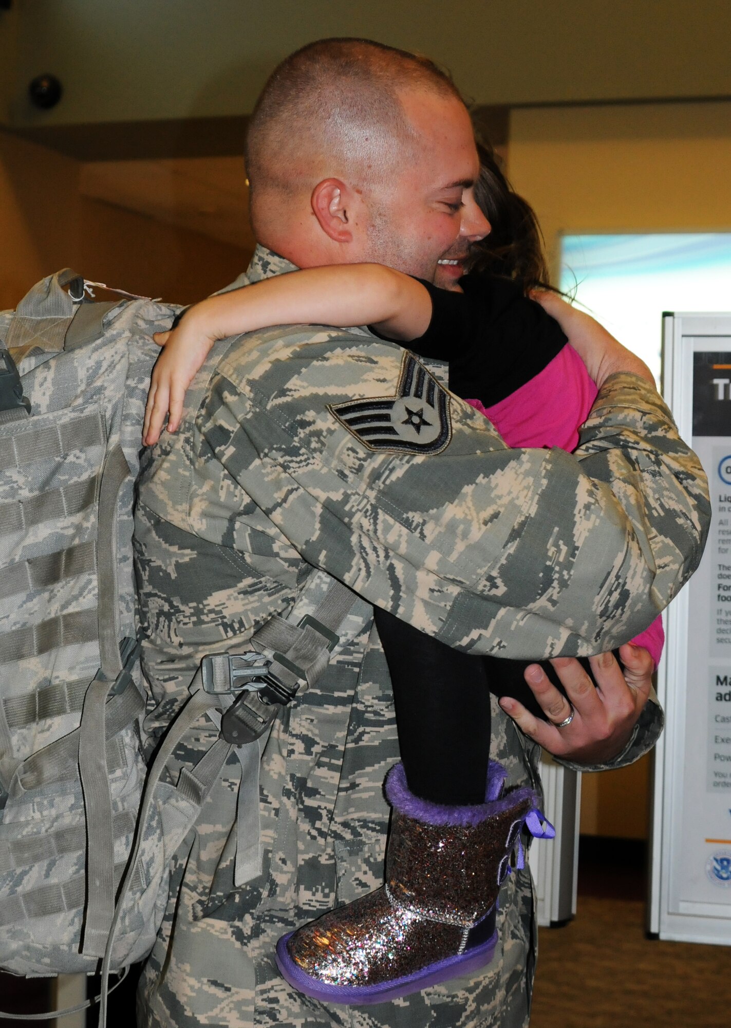 Staff Sgt. Shawn Hollis reunites with his family at the Fort Smith (Ark.) Regional Airport Nov. 27, 2013, following a six-month deployment to the Middle East.  Hollis was one of 13 Airmen with the 188th Security Forces Squadron who returned just in time to spend the Thanksgiving holiday with his family. (U.S. Air National Guard photo by Maj. Heath Allen/188th Fighter Wing)