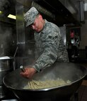 U.S. Air Force Airman 1st Class Jim Mesa, 100th Force Support Squadron food specialist, mashes potatoes for the Thanksgiving lunch Nov. 28, 2013, held at the Gateway Dining Facility on RAF Mildenhall, England. The cooks prepared lunch for approximately 250 members of Team Mildenhall. (U.S. Air Force photo by Senior Airman Kate Maurer/Released)