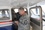 A member of the 192nd Intelligence Squadron prepares for a flight in a Civil Air Patrol aircraft worked together with the Civil Air Patrol during Commonwealth Guardian, a training exercise where members of the squadron worked with CAP personnel to deliver real-time geospatial information of areas affected by a simulated severe weather event.