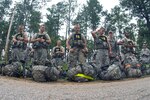 Competitors in the 2012 Army National Guard Best Warrior Competition mentally prepare themselves for a night ruck march to be conducted for an undetermined distance during Competition at Fort Benning, Ga., July 31, 2012. The Army National Guard competition, as it is today, can credit its beginnings to Command Sgt. Maj. John Gipe, former command sergeant major of the Army National Guard, who in 2006 set about revamping the competition.