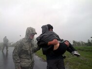 An Airmen from the Louisiana Air National Guard assists local authorities with evacuating residents of Braithwaite, La., in Plaquemines Parish as Hurricane Isaac makes landfall, Aug. 29, 2012. Louisiana Guard members were in place prior to Isaac making landfall and have been assisting local authorities with safety and security throughout the area.