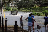 Soldiers with the Mississippi Army National Guard’s Headquarters and Headquarters Company, 1st Combined Arms Battalion, 155th Infantry Regiment help Hancock County, Miss. deputies make contact with individuals stranded in Gulfport, Miss., as storm surge from Hurricane Isaac surge rises over the sea wall, Aug. 28, 2012. Approximately 1500 members of the Mississippi Guard have been called out in response to the storm.