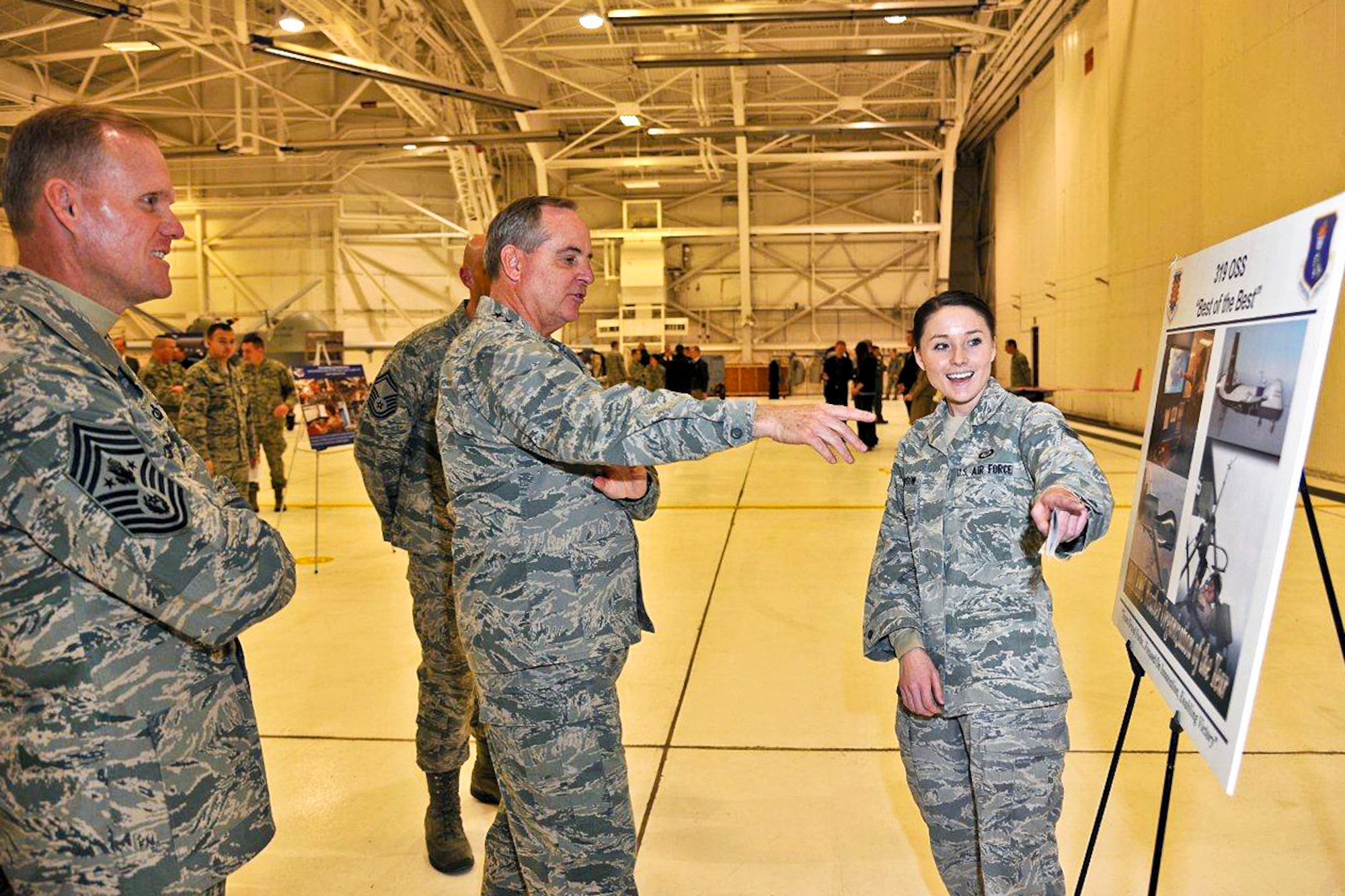 Staff Sgt. Amanda Davidson briefs Air Force Chief of Staff Gen. Mark A. Welsh III and Chief Master Sgt. of the Air Force James A. Cody, Nov. 26, 2013, on Grand Forks Air Force Base, N.D. Davidson is a  319th Operations Support Squadron weather forecaster. (U.S. Air Force photo/Senior Airman Xavier Navarro)