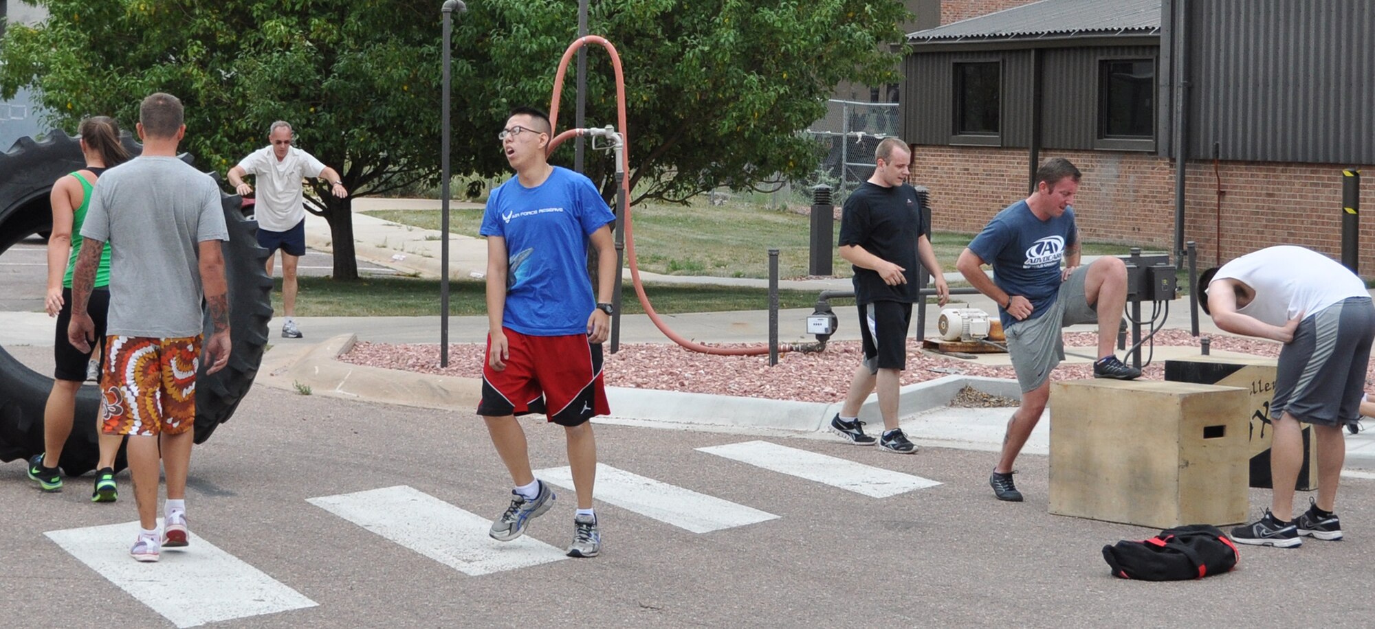 CrossFit trainees try to catch their breath during a typical daily workout. Members of several different units make-up the daily cross fit training regiments. What started out as a group of five is now twenty strong. (U.S. Air Force photo/Master Sgt. Daniel Butterfield)