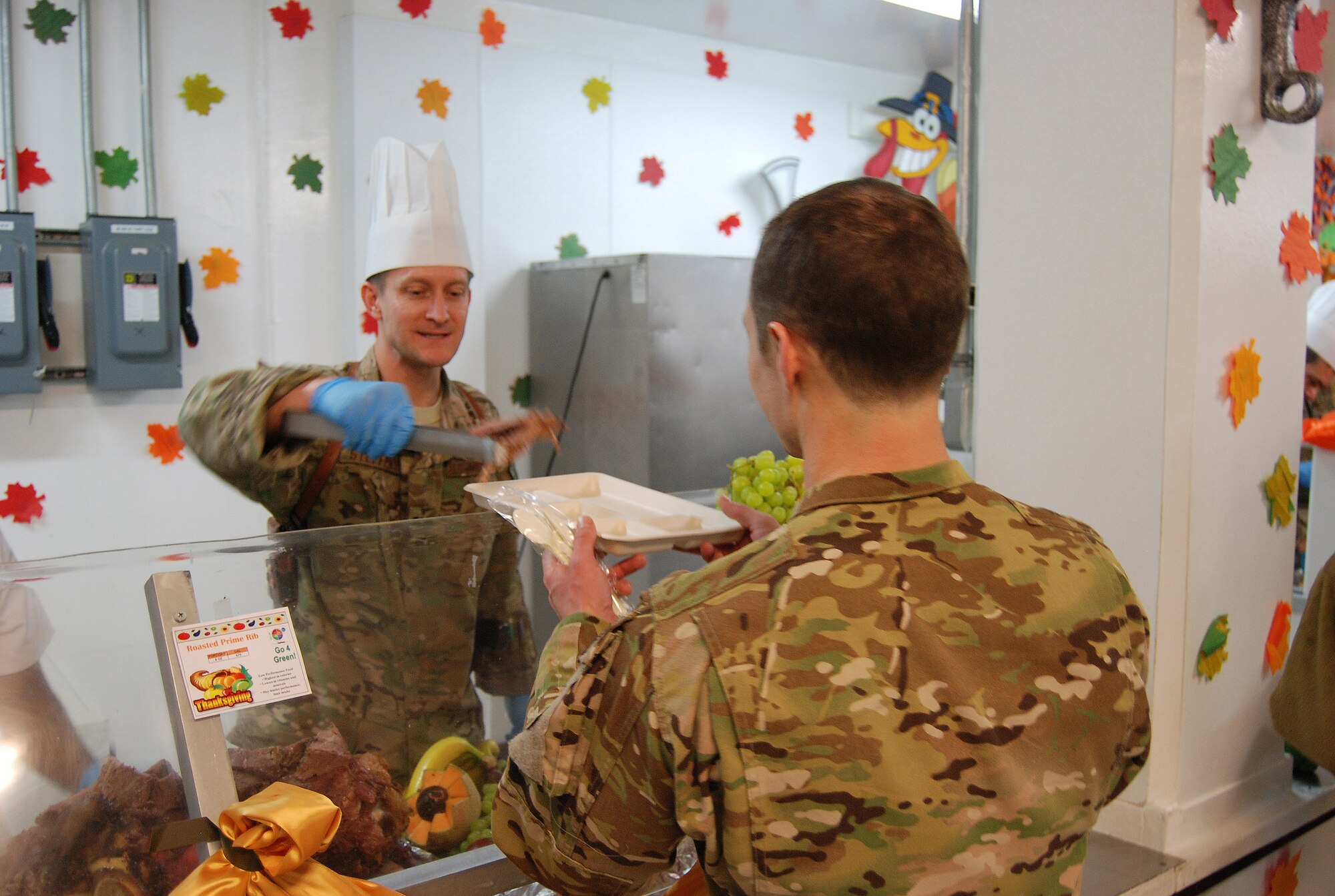 Col. Aaron Steffens, 455th Air Expeditionary Wing vice commander, serves Thanksgiving meals to service members here, November 28, 2013. Various military senior leaders stepped in to serve food at the dining facilities at Bagram Airfield.  (U.S. Air Force Photo by Capt. Brian Wagner)