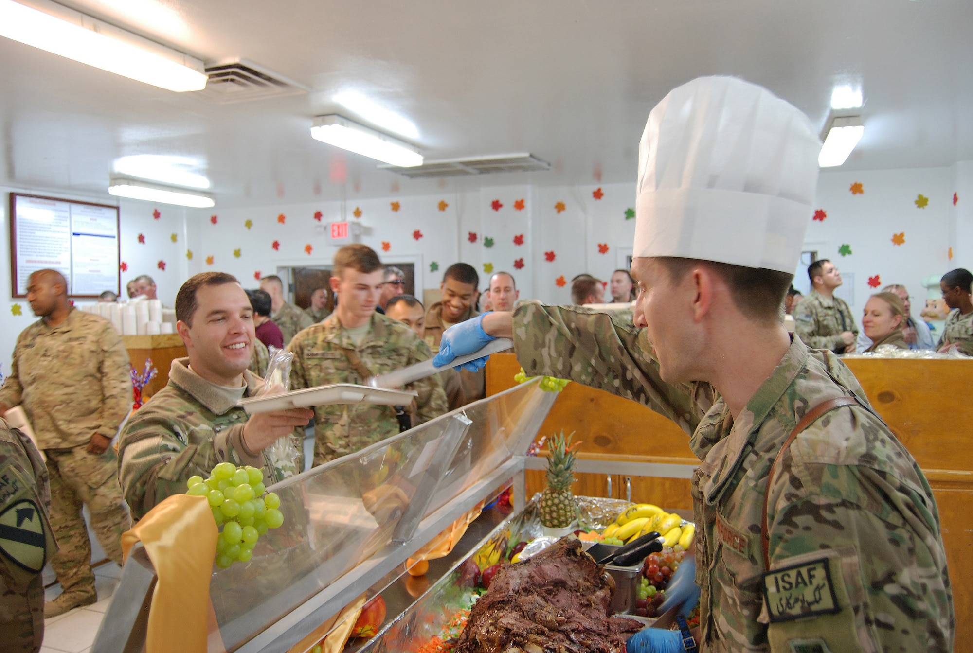 Col. Aaron Steffens, 455th Air Expeditionary Wing vice commander, serves Thanksgiving meals to service members here, November 28, 2013. Various military senior leaders stepped in to serve food at the dining facilities at Bagram Airfield.  (U.S. Air Force Photo by Capt. Brian Wagner)