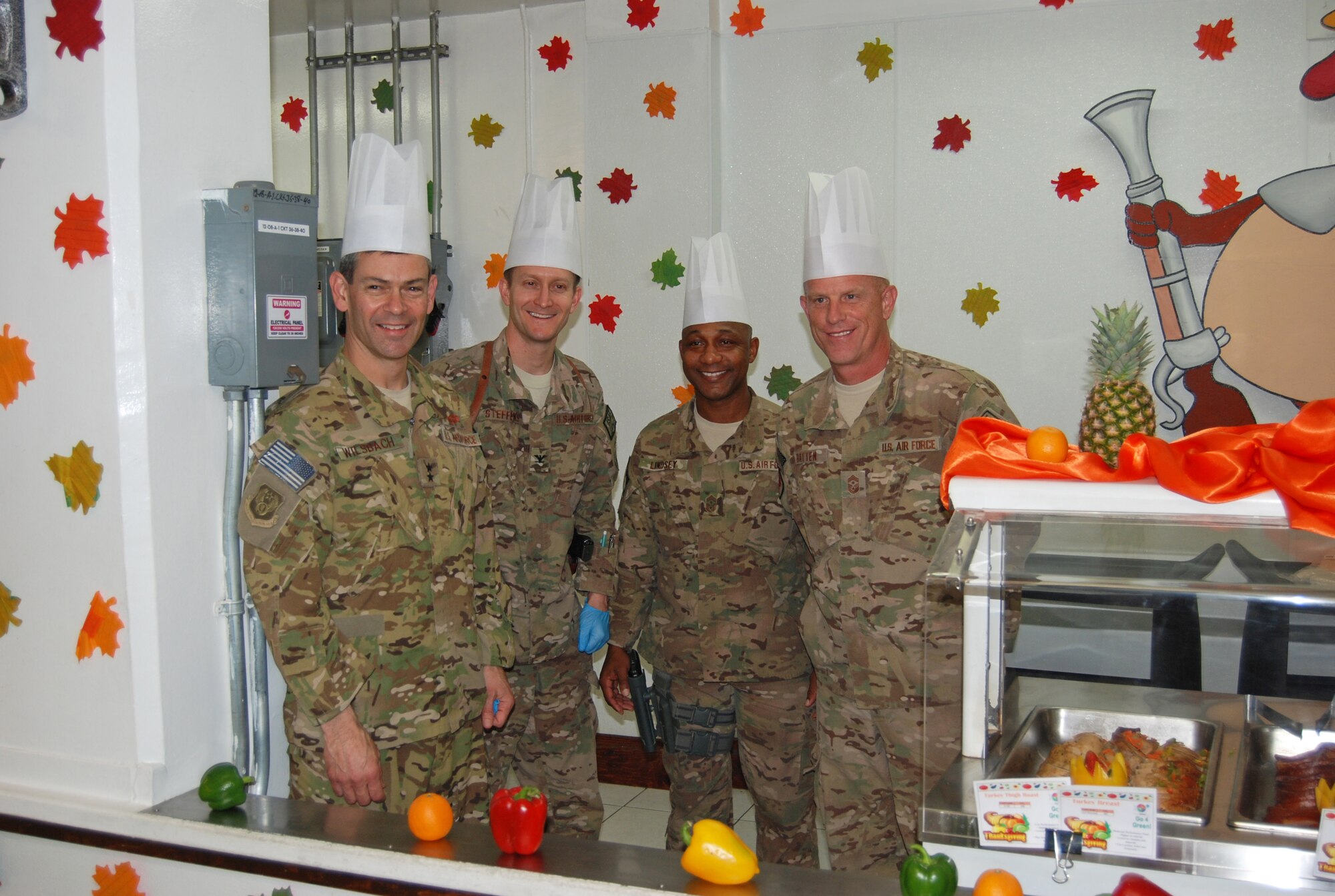 Air Force Maj. Gen. Ken Wilsbach, 9th Air and Space Expeditionary Task Force- Afghanistan; Deputy Commander-Air, U.S. Forces-Afghanistan; and Deputy Chief of Staff-Air, International Security Assistance Force Joint Command commander(left), Col. Aaron Steffens, 455th Air Expeditionary Wing vice commander, Chief Master Sgt. Kenneth Lindsey, Command Chief Master Sergeant of the 455th Air Expeditionary Wing and Chief Master Sergeant Frank Batten III, 9th Air and Space Expeditionary Task Force- Afghanistan command chief get ready to serve Thanksgiving dinner to hundreds of service members at the Dragon DFAC here, November 28, 2013. Various senior leaders took shifts serving dinner to service members, civilians and contractors at Bagram Airfield, Afghanistan.  (U.S. Air Force Photo by Capt. Brian Wagner)