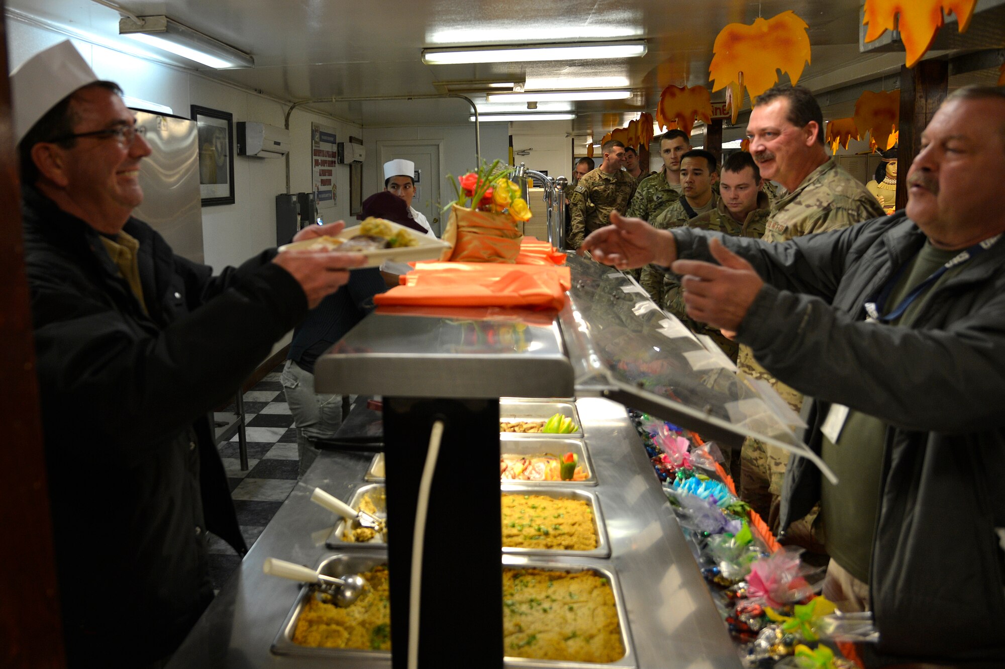 Mr. Ashton Carter, U.S. Deputy Secretary of Defense, and his wife, Mrs. Stephanie Carter, serve Thanksgiving dinner for Service members at Bagram Airfield, Afghanistan, Nov. 28, 2013. The Carter’s served Service members dinner before joining them for dinner themselves. (U.S. Air Force photo by Senior Airman Kayla Newman)