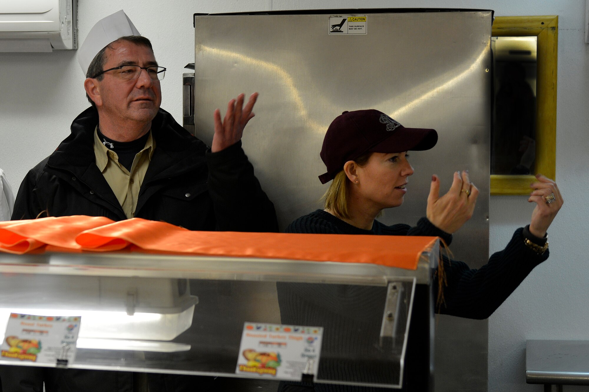 Mr. Ashton Carter, U.S. Deputy Secretary of Defense, and his wife, Mrs. Stephanie Carter, wave for personnel to come receive a Thanksgiving meal at Bagram Airfield, Afghanistan, Nov. 28, 2013. The Carter’s served Service members dinner before joining them for dinner themselves. (U.S. Air Force photo by Senior Airman Kayla Newman)