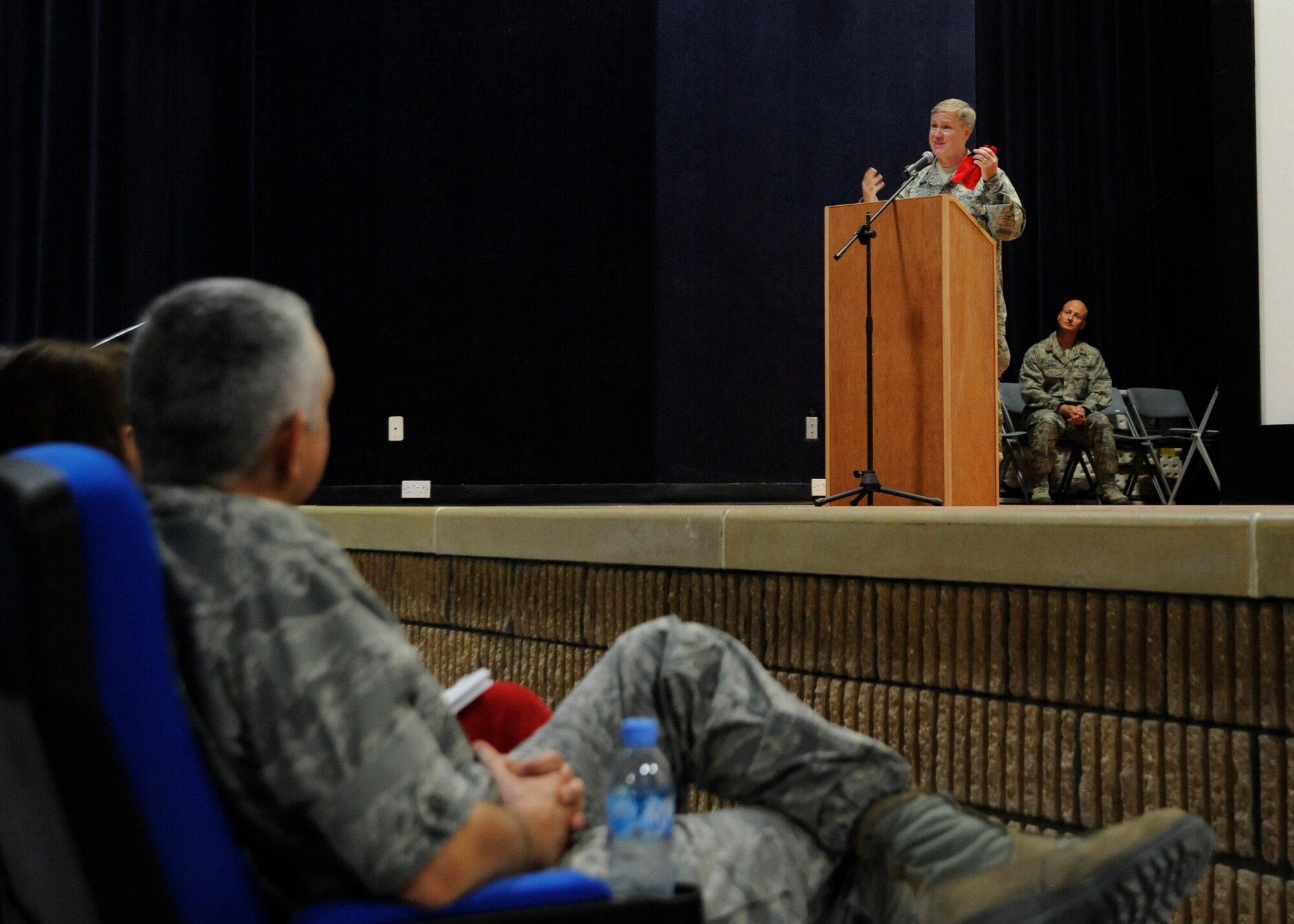 Chaplain (Col.) Steve Keith delivers a Thanksgiving message during the Interfaith Thanksgiving service at the 379th Air Expeditionary Wing in Southwest Asia, Nov. 28, 2013. The red gloves were from an anecdote he shared about his childhood, reminding attendees to be thankful. Keith is the 379th AEW wing chaplain deployed from Fort Jackson, S.C., and a Flint, Mich., native. (U.S. Air Force photo/Senior Airman Bahja J. Jones) 