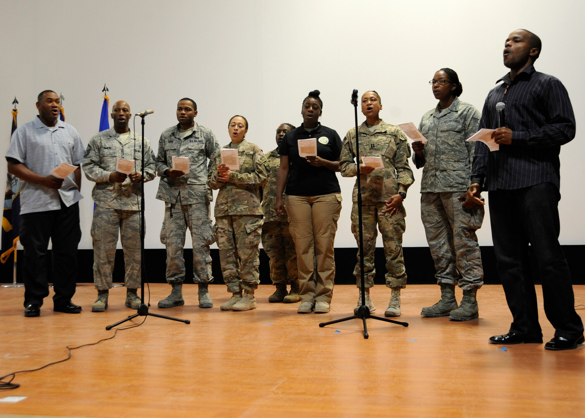 A combined Victory Chapel choir leads attendees in singing “America the Beautiful” during the Interfaith Thanksgiving service at the 379th Air Expeditionary Wing in Southwest Asia, Nov. 28, 2013. The Victory Chapel staff put together the Thanksgiving celebration, bringing together deployed service personnel of all religious faiths. (U.S. Air Force photo/Senior Airman Bahja J. Jones) 