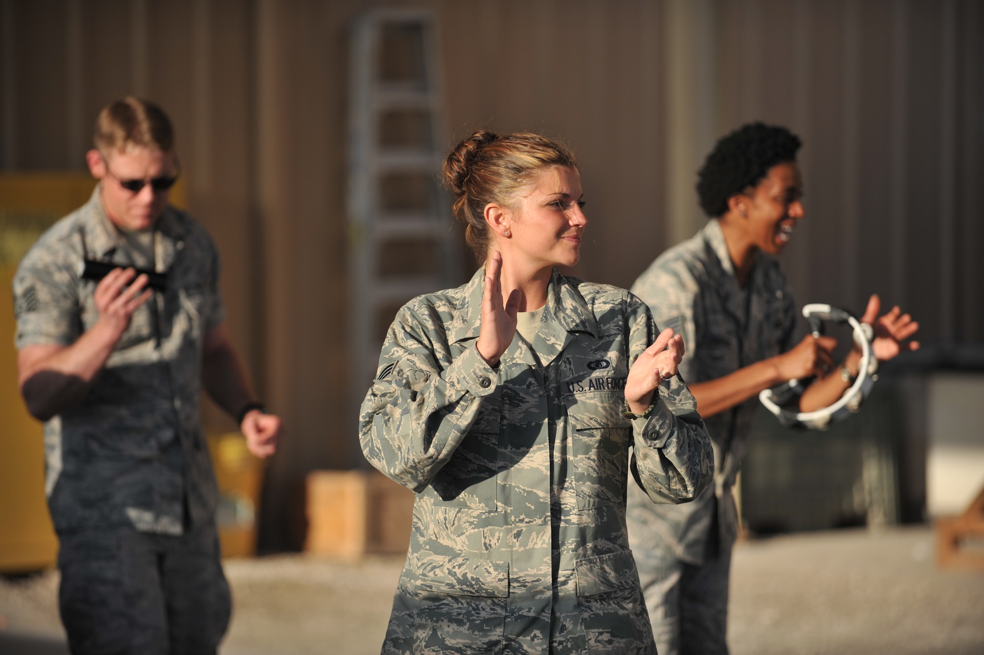 Staff Sgt. Kelly Perry sings to service members at the 8th Expeditionary Air Mobility Squadron passenger terminal, 379th Air Expeditionary Wing, Southwest Asia on Nov. 27, 2013. Systems Go is the newest U.S. Air Forces Central Command rock band and will provide performances to increase troop morale, diplomacy, and outreach to host nations. Perry is a vocalist and is deployed from Wright-Patterson Air Force Base, Ohio, and hails from Louisville, Ky. (U.S. Air Force photo/Master Sgt. David Miller)