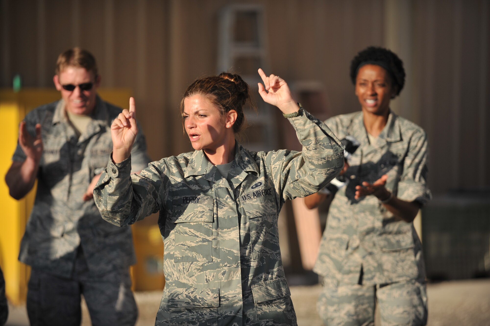 Staff Sgt. Kelly Perry sings to service members at the 8th Expeditionary Air Mobility Squadron passenger terminal, 379th Air Expeditionary Wing, Southwest Asia on Nov. 27, 2013. Systems Go is the newest U.S. Air Forces Central Command rock band and will provide performances to increase troop morale, diplomacy, and outreach to host nations. Perry is a vocalist and is deployed from Wright-Patterson Air Force Base, Ohio, and hails from Louisville, Ky. (U.S. Air Force photo/Master Sgt. David Miller)