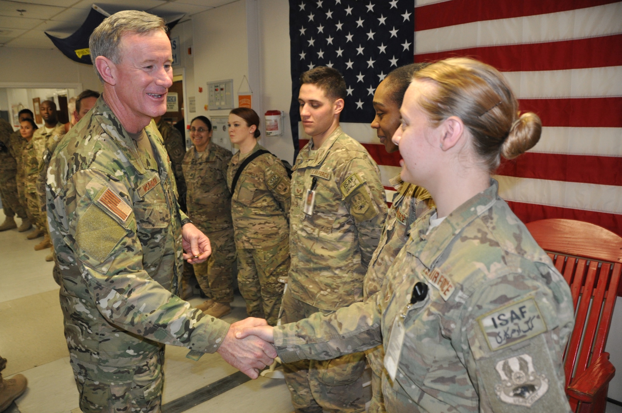 Admiral William H. McRaven, commander, Special Operations Command, greets a hospital staff member from the Heathe N. Craig Joint Theater Hospital during a Thanksgiving day visit at Bagram Airfield, Afghanistan, Nov. 28, 2013. (U.S. Air Force Photo/Tech. Sgt. Rob Hazelett)
