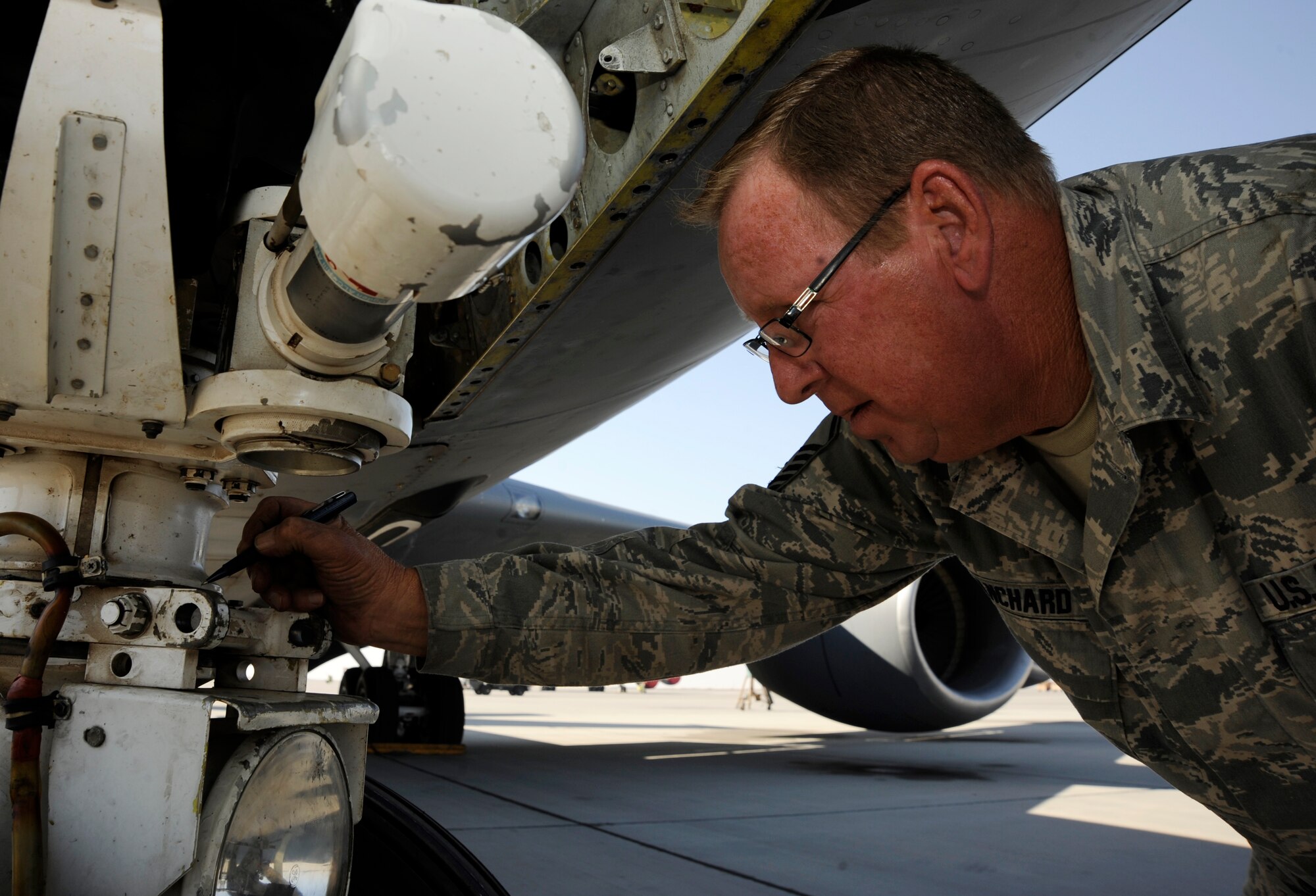 Master Sgt. Timothy Blanchard marks the nose wheel steering travel during an operations check after reinstallation on a KC-135 Stratotanker at the 379th Air Expeditionary Wing in Southwest Asia, Nov. 26, 2013. The Aero Repair shop has performed more than 350 major aircraft repairs this year saving the Air Force money in maintenance and estimated shipping costs.Blanchard is a 379th Expeditionary Maintenance Squadron repair and reclamation technician deployed from the 117th Air Refueling Wing in Birmingham, Ala., and a Sylacauga, Ala., native.  (U.S. Air Force photo/Senior Airman Bahja J. Jones) 