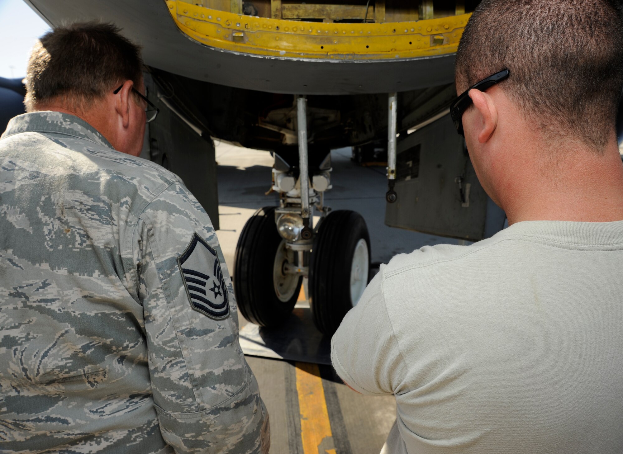 Master Sgt. Timothy Blanchard and Tech. Sgt. Ronald Martin examine the nose wheel steering travel on a KC-135 Stratotanker during an operations check at the 379th Air Expeditionary Wing in Southwest Asia, Nov. 26, 2013. The Aero Repair shop has performed more than 350 major aircraft repairs this year saving the Air Force money in maintenance and estimated shipping costs. Blanchard is a 379th Expeditionary Maintenance Squadron AR shop repair and reclamation technician deployed from the 117th Air Refueling Wing in Birmingham, Ala., and a Sylacauga, Ala., native. Martin is the 379th EMXS AR shop KC-135 team leader deployed from the 134th Air Refueling Wing at McGhee Tyson Air National Guard Base, Tenn., and a Johnson City, Tenn., native. (U.S. Air Force photo/Senior Airman Bahja J. Jones) 