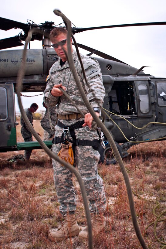 Army Sgt. 1st Class Jeremy Stanton untangles a rope during rappel testing on Fort Hood, Texas, Nov. 20, 2013. Stanton is an air assault instructor.