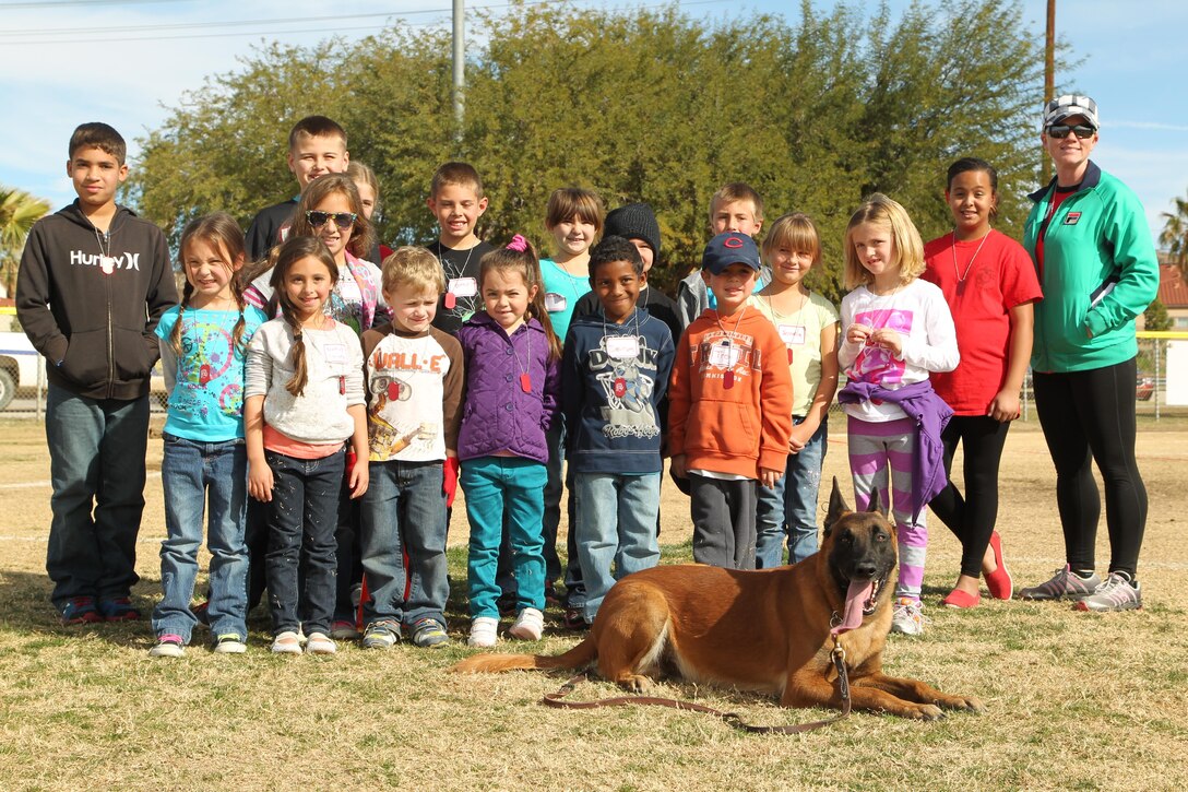 Children aboard the Combat Center watched a demonstration of Cchaz, a military working dog, during a mock combined-arms exercise for kids at Felix Field Nov. 26, 2013