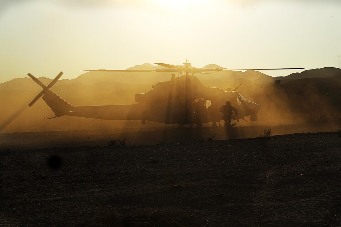 Marines perform Cherry-picker drills with a UH-1Y Huey helicopter during a Combat Logistics Patrol in the Combat Center’s Lava Lake training area Nov. 15, 2013.