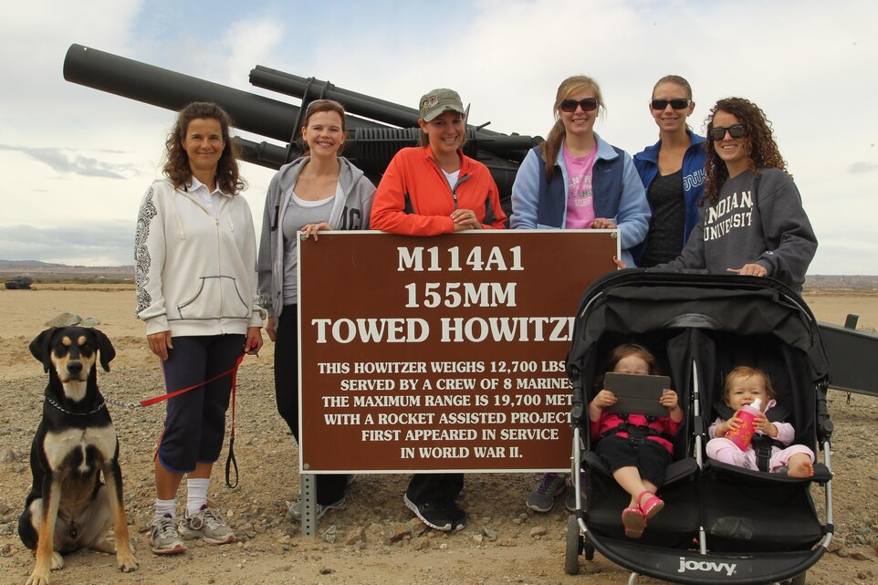 [From left to right] Vera Savage, Amanda Kendrick, Deana Storer, Laura Larson, Julie Azua, and Julia Cramer, members of the Sweating Bullets fitness club, pose in front of a decommissioned Howitzer placed alongside the Physical Fitness test track aboard the Combat Center Nov. 21, 2013.
