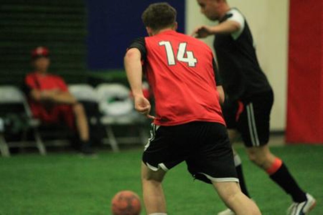Samuel Duncan, a soccer player with 2nd Battalion, 7th Marine Regiment's team, sprints across the playing field during an indoor soccer match at the East Gym Nov. 20, 2013.